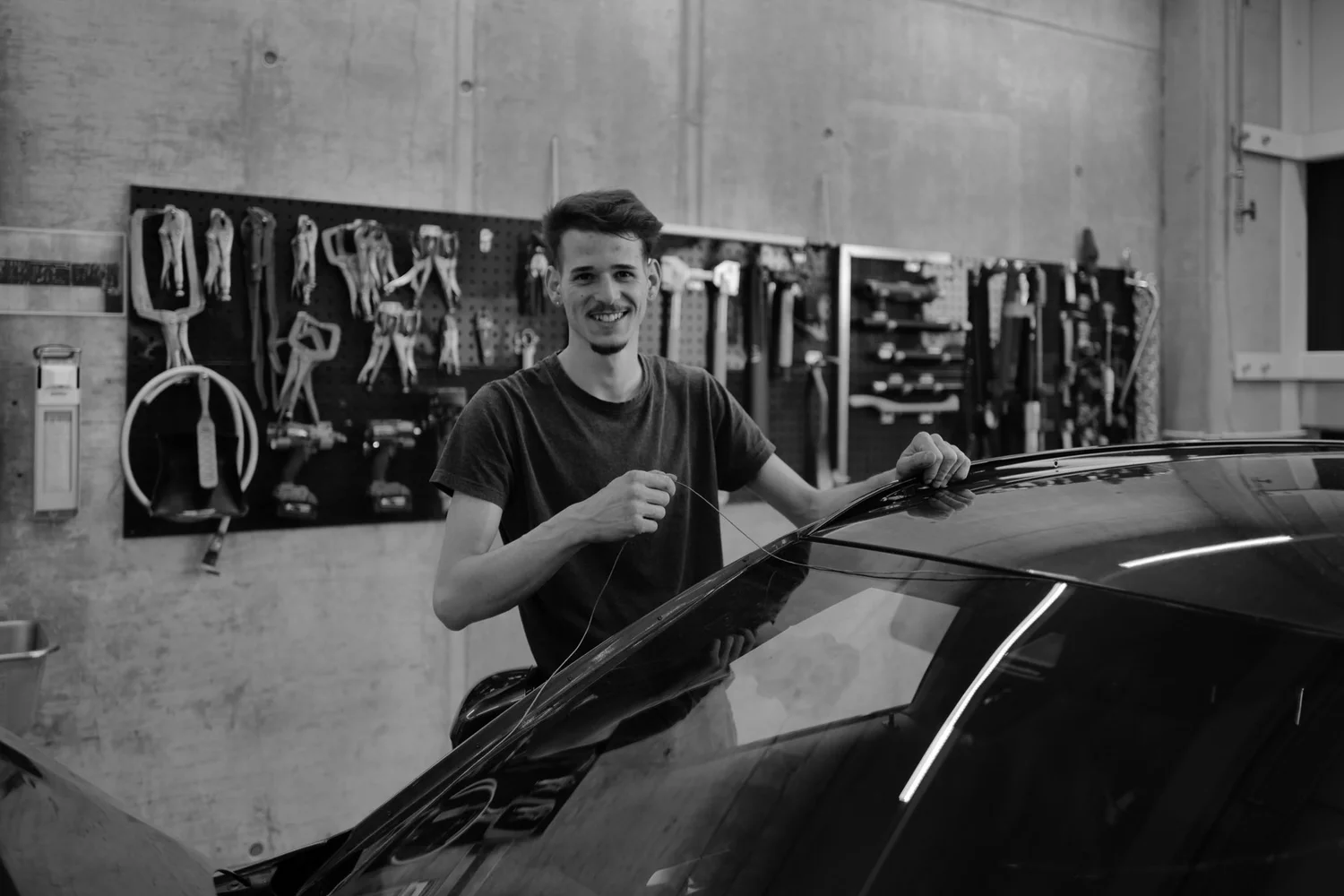 A worker at the windscreen of a vehicle