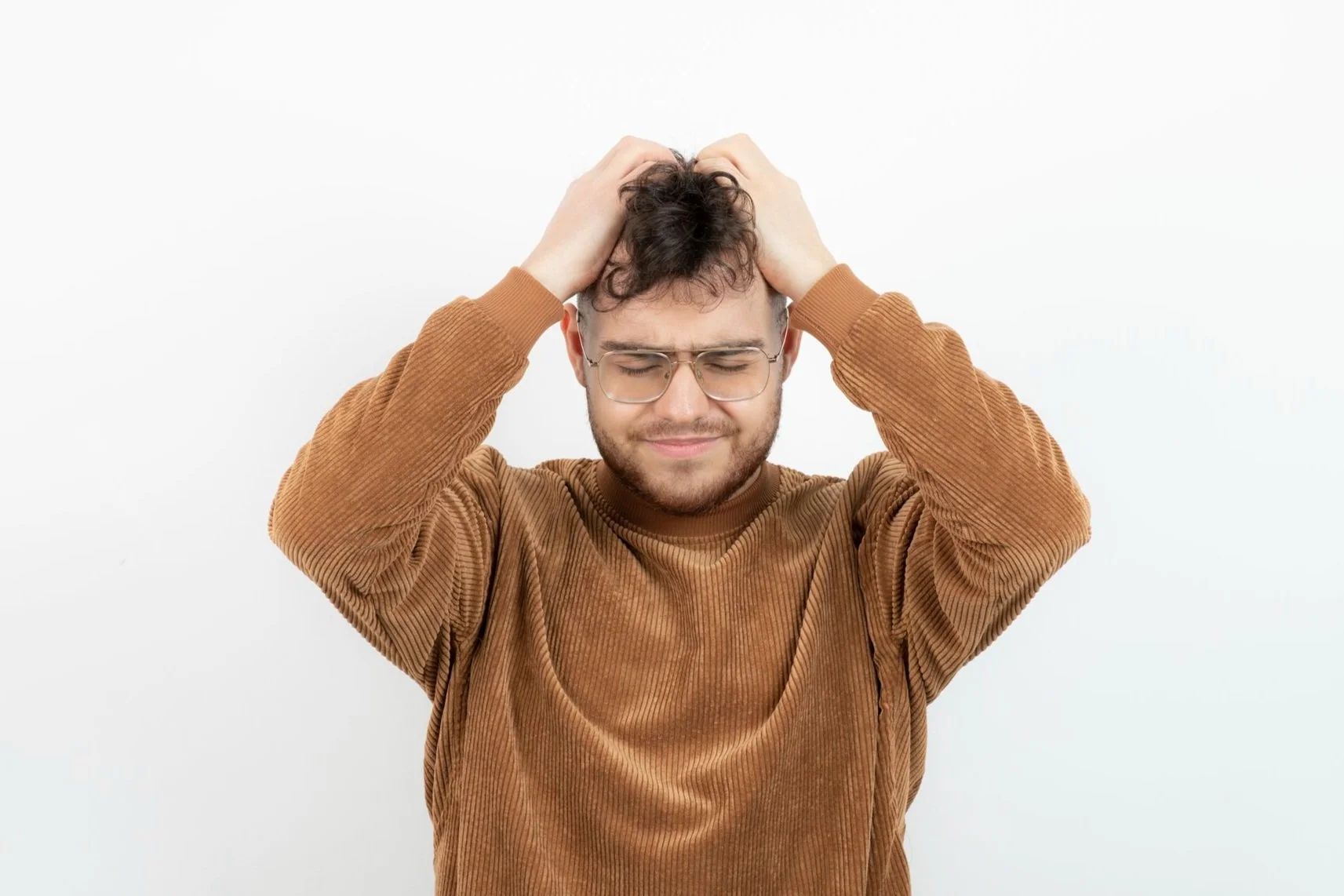 young-man-glasses-holding-his-head-white.jpg