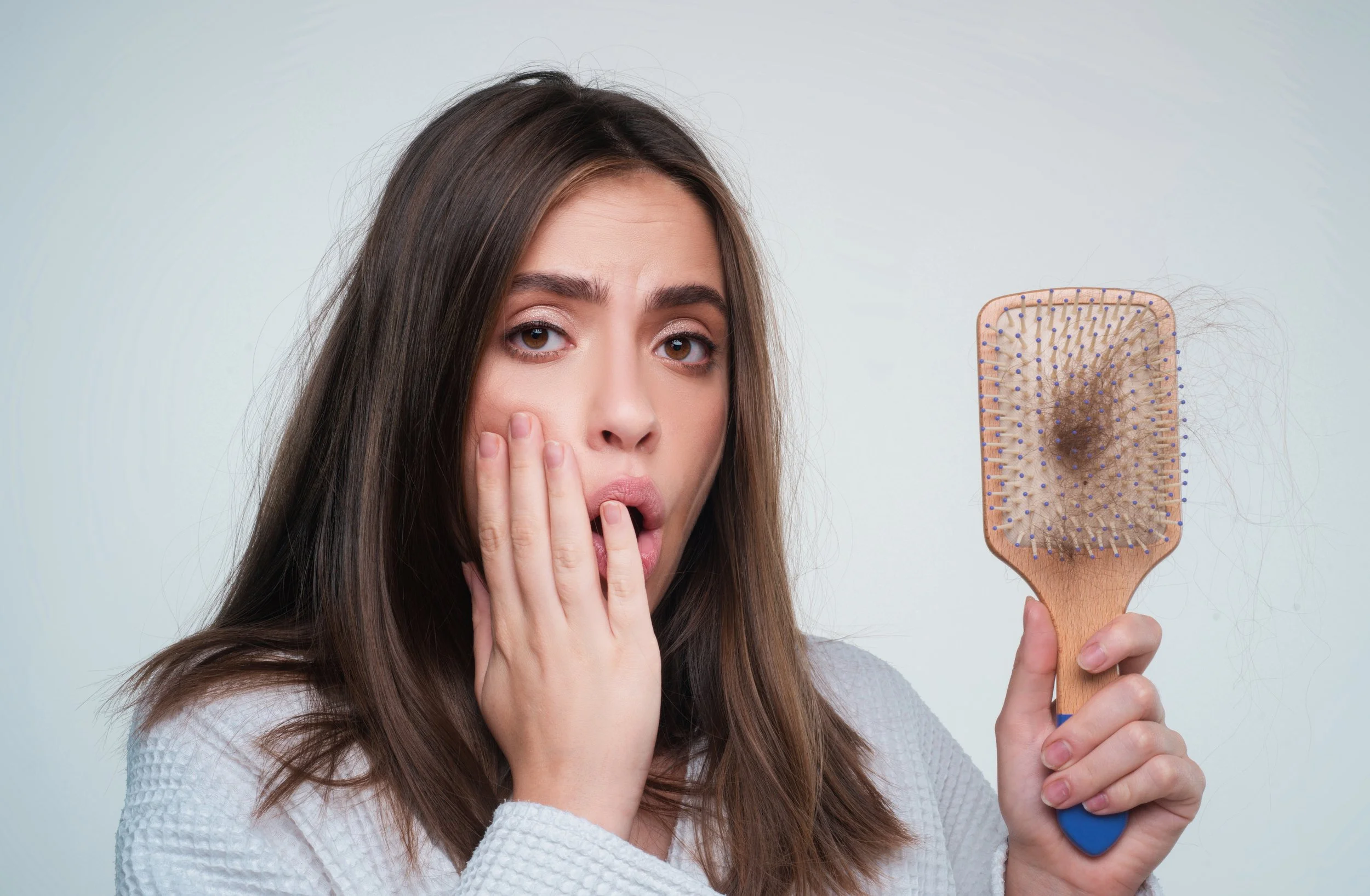 closeup-hair-loss-hair-fall-hairbrush-stress-problem-woman-with-comb.jpg