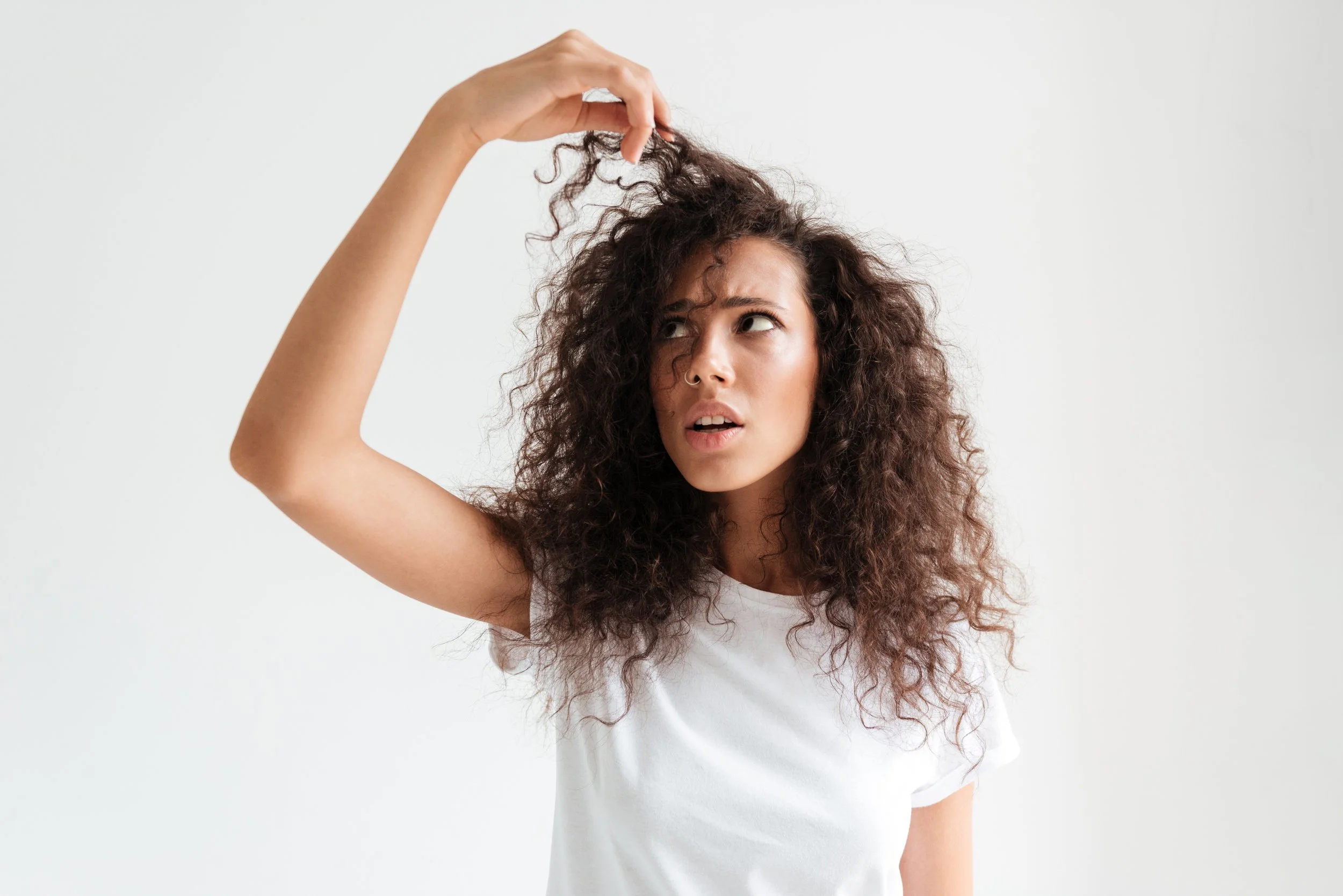 portrait-confused-young-woman-looking-her-hair.jpg