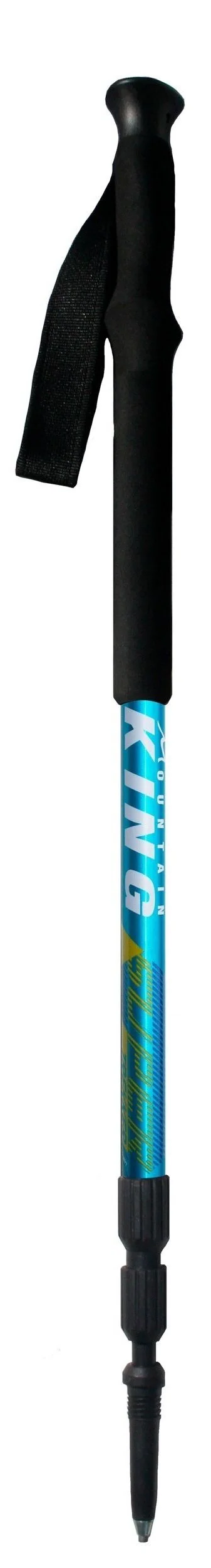 Close-up of a person's hands gripping hiking poles with wrist straps, poles angled forward as they trek across uneven terrain