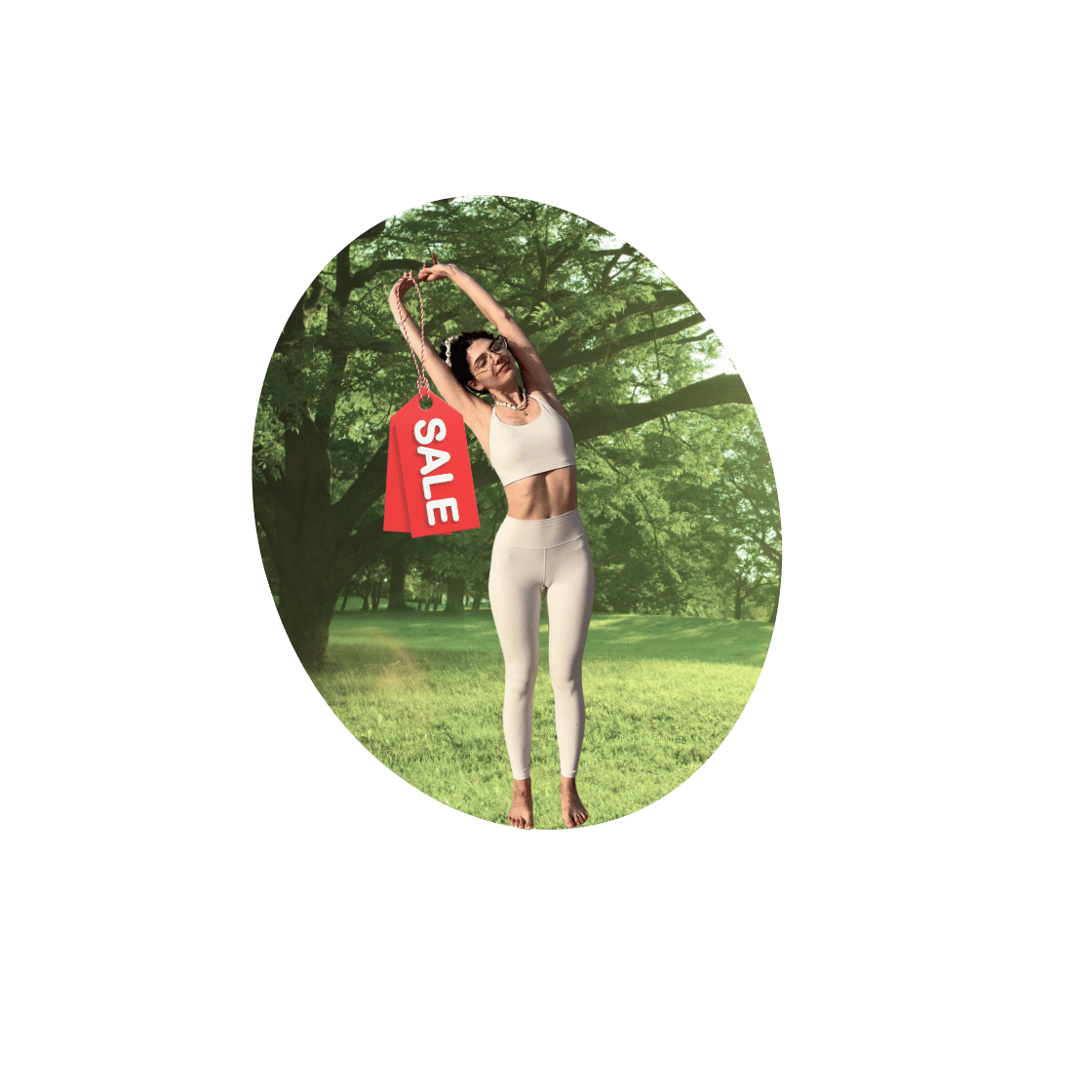 Woman in athletic wear holding a sale sign in a park with green trees in the background.