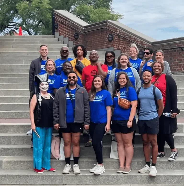 Step Up outreach team posing together outdoors during a community event, representing free anonymous STD and HIV testing resources.