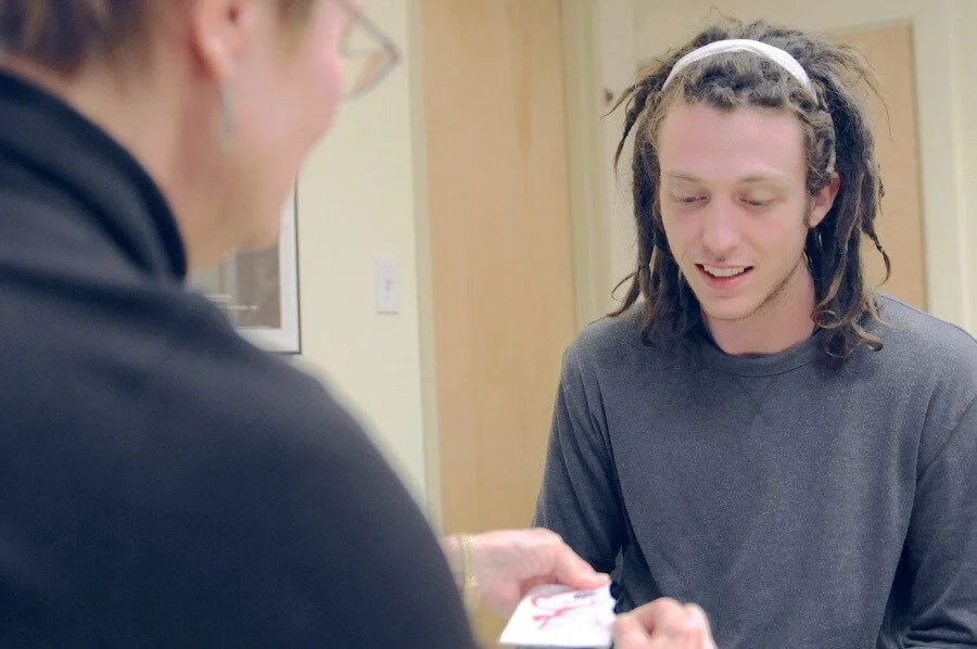 Healthcare worker providing free HIV testing assistance to a client at the Damien Center in Indianapolis.”