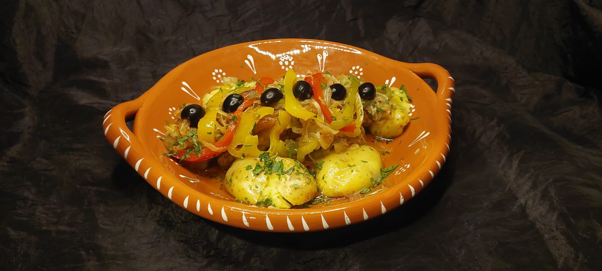 BACALHAU DE CEBOLADA - Cod loin sautéed with onions, peppers, and garlic in olive oil, served with boiled potatoes and finished with olives, 19,50€