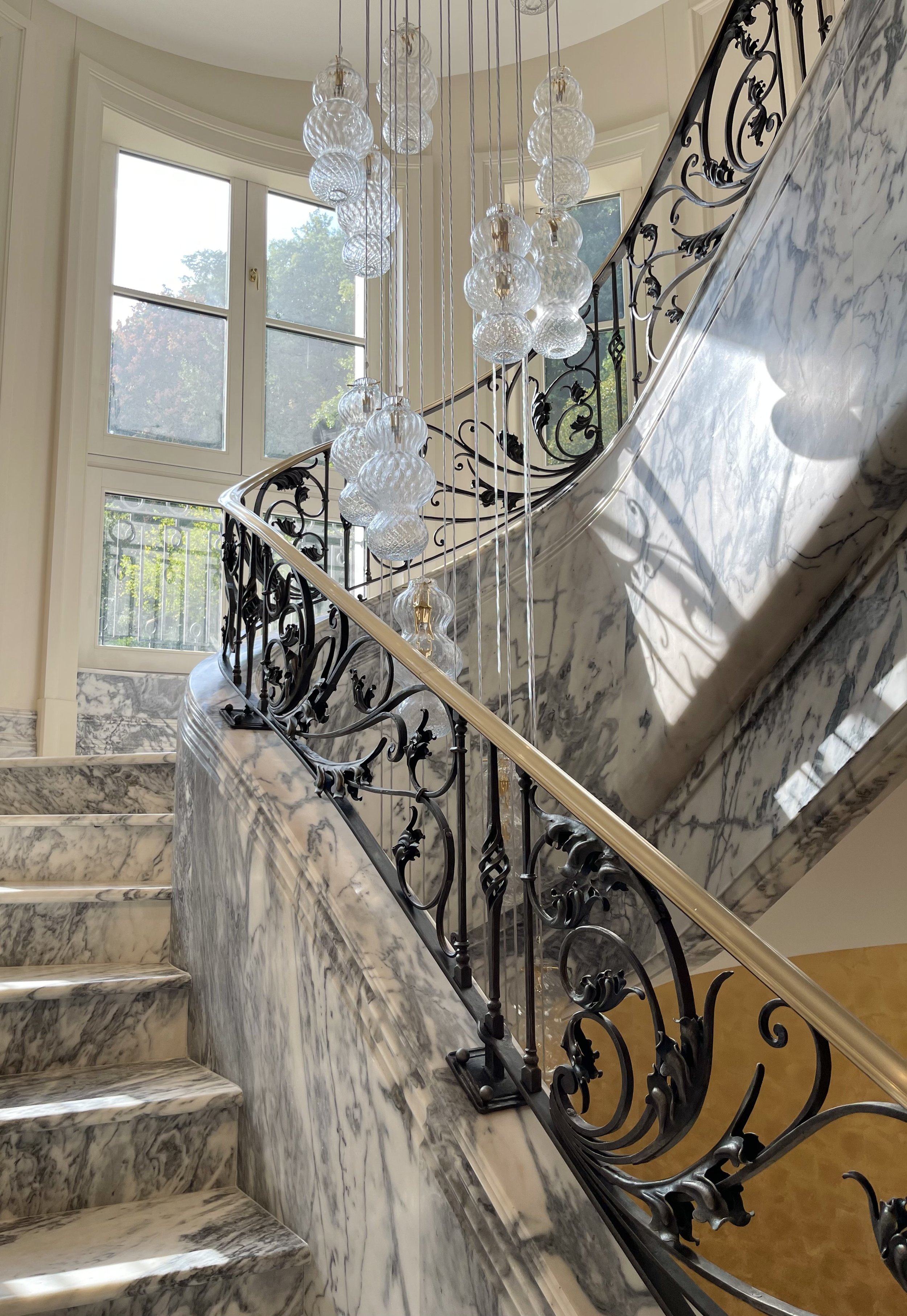 Marble staircase with bespoke wrought iron railings