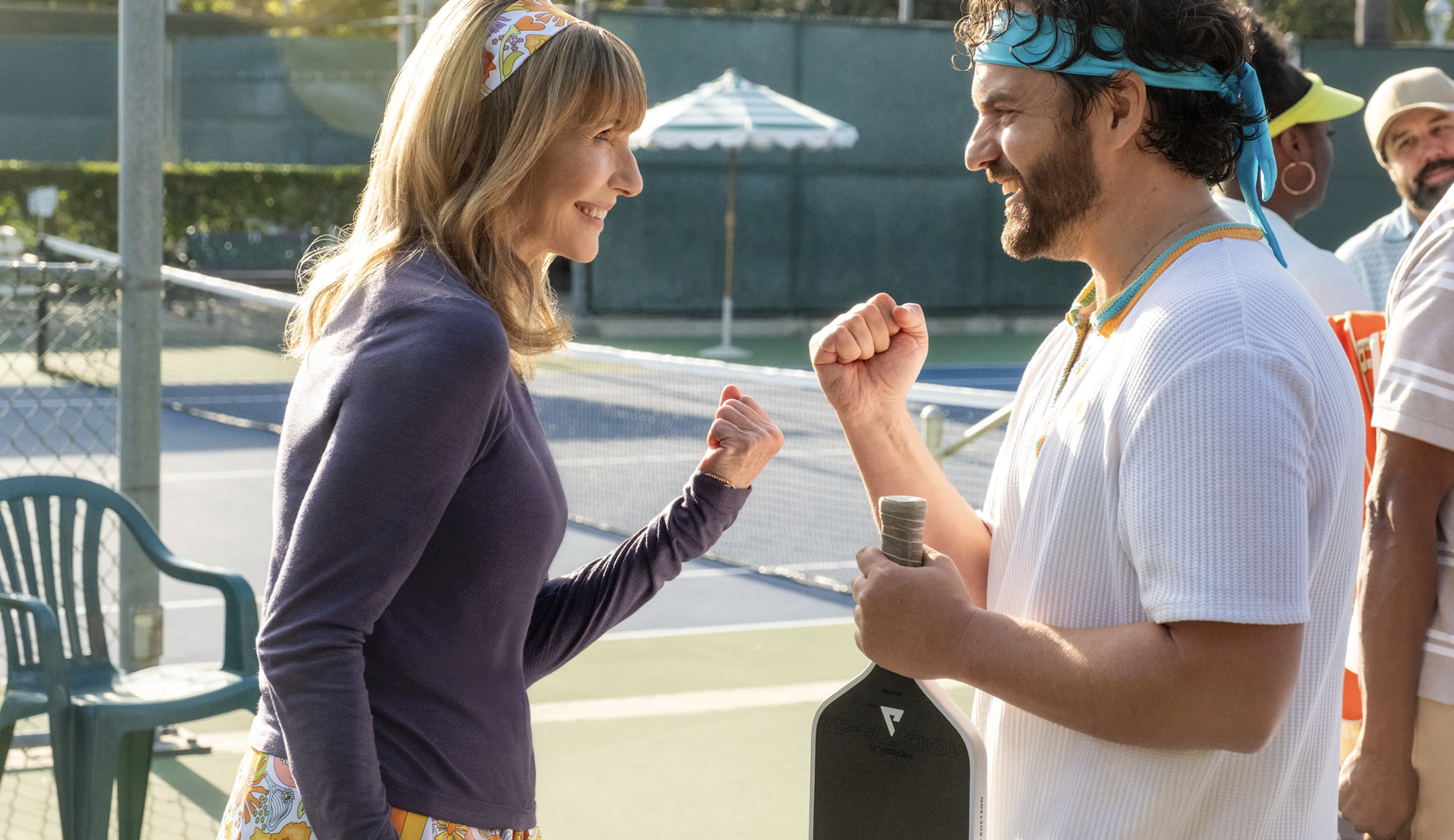 Mary Steenburgen and Jake Johnson facing each other on pickleball court