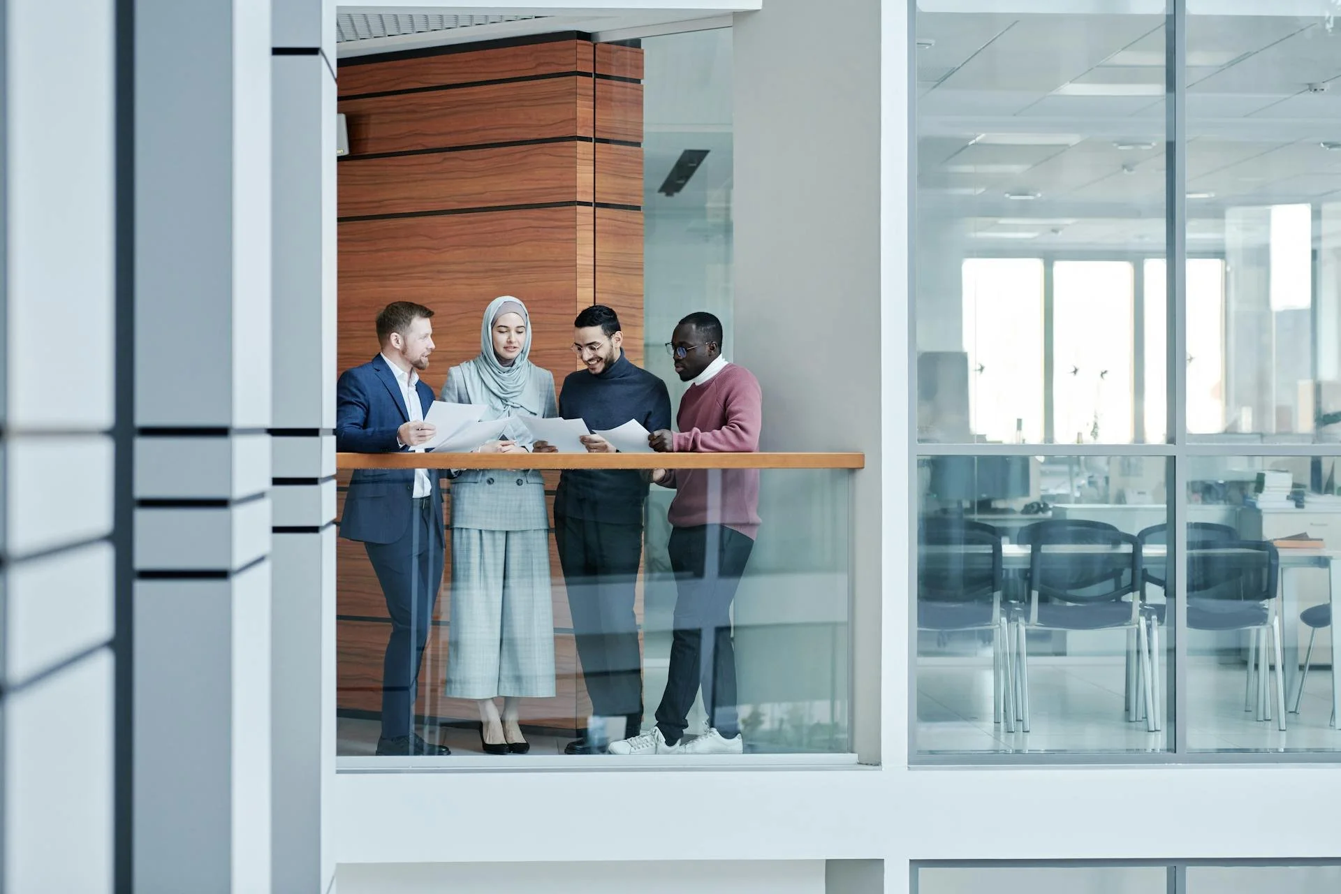 diverse group of employees looking at papers together in an office