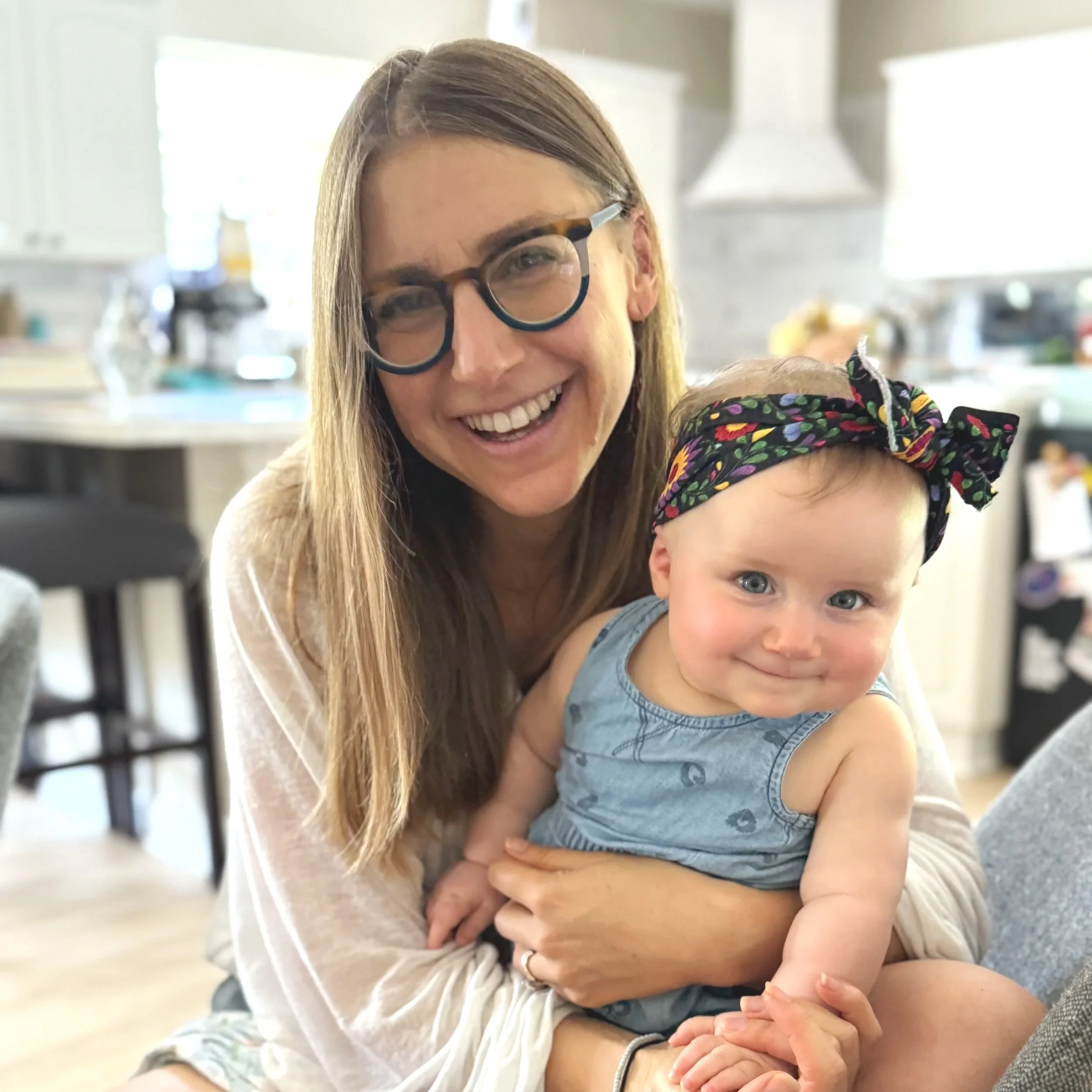 Dr. Alyssa Birnbaum holding her daughter on her lap