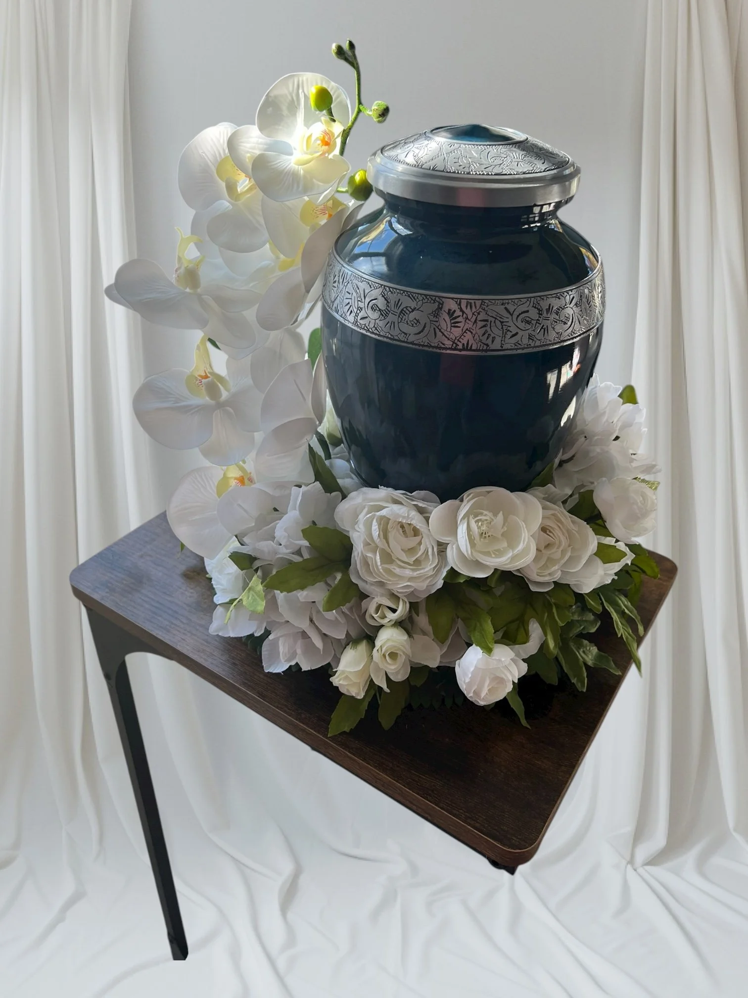 White silk roses, hydrangeas,  orchid and Cala Lilys  Urn not included.