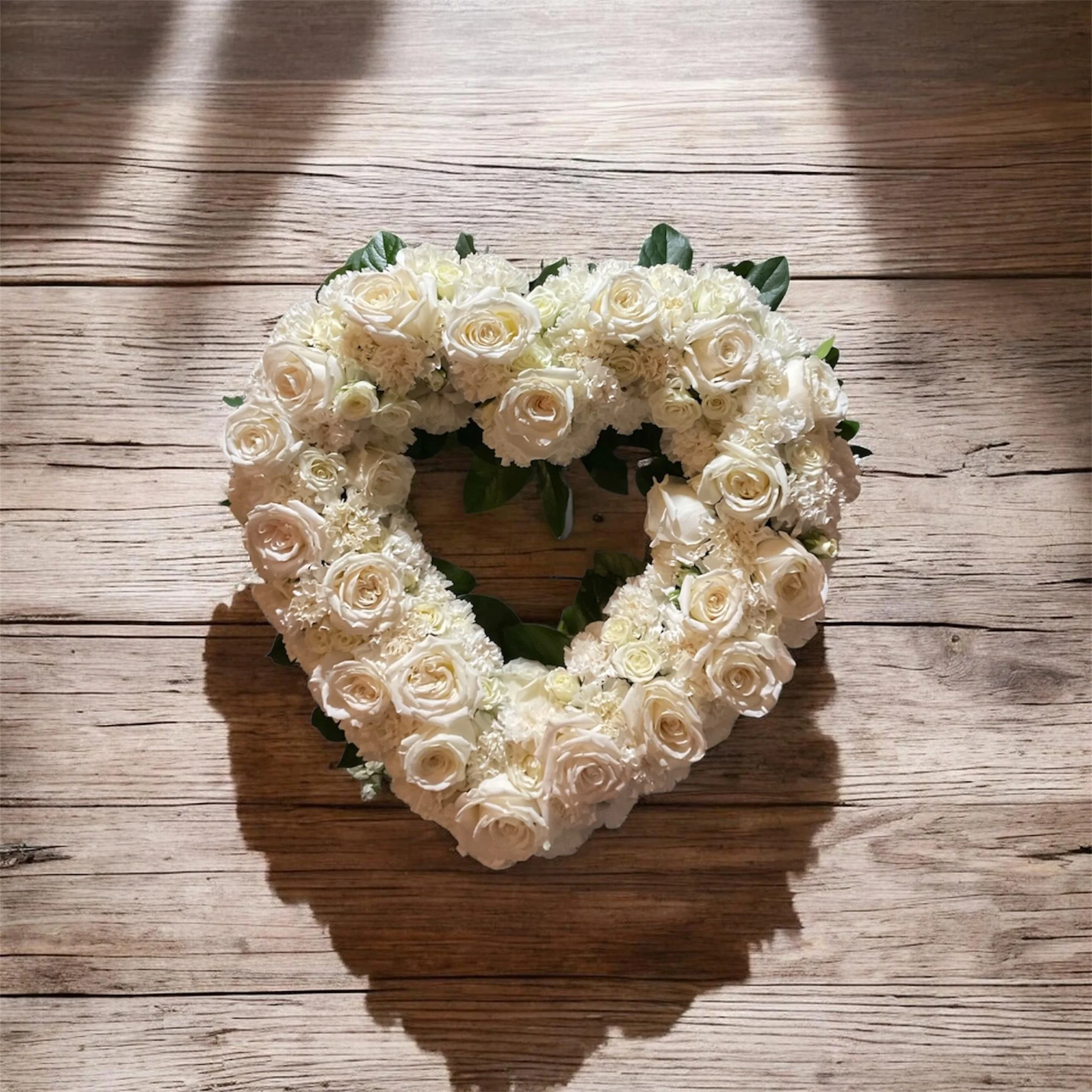 White roses and carnations open heart starting $195.00
