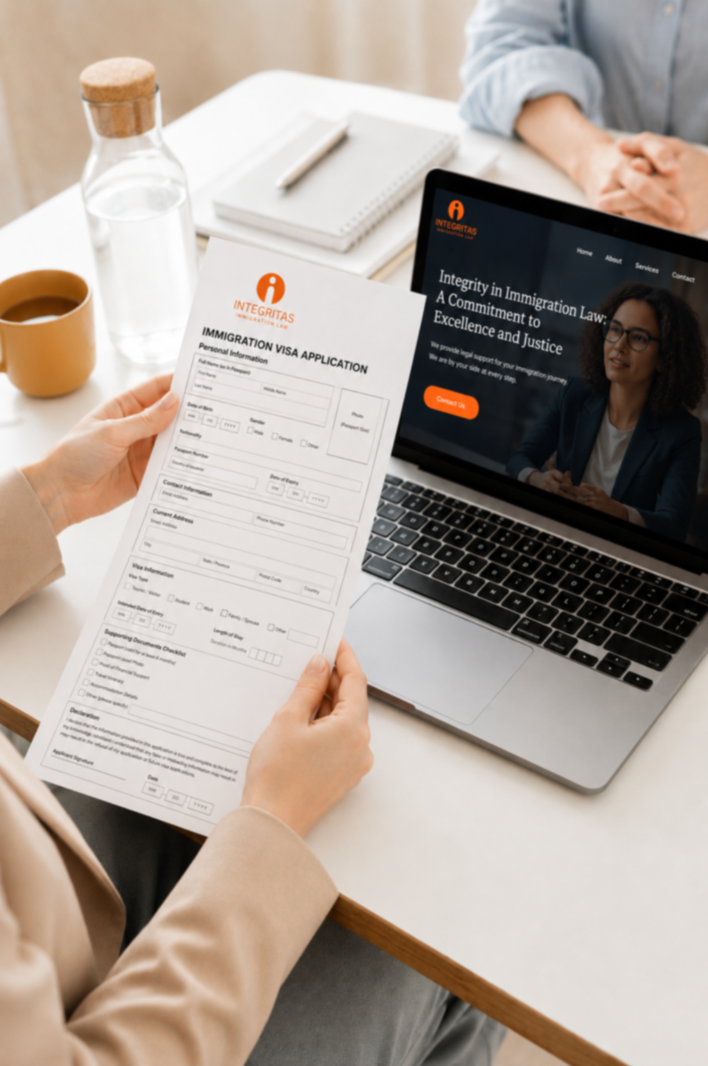 Integritas Immigration Law visa application form and website displayed on laptop during consultation