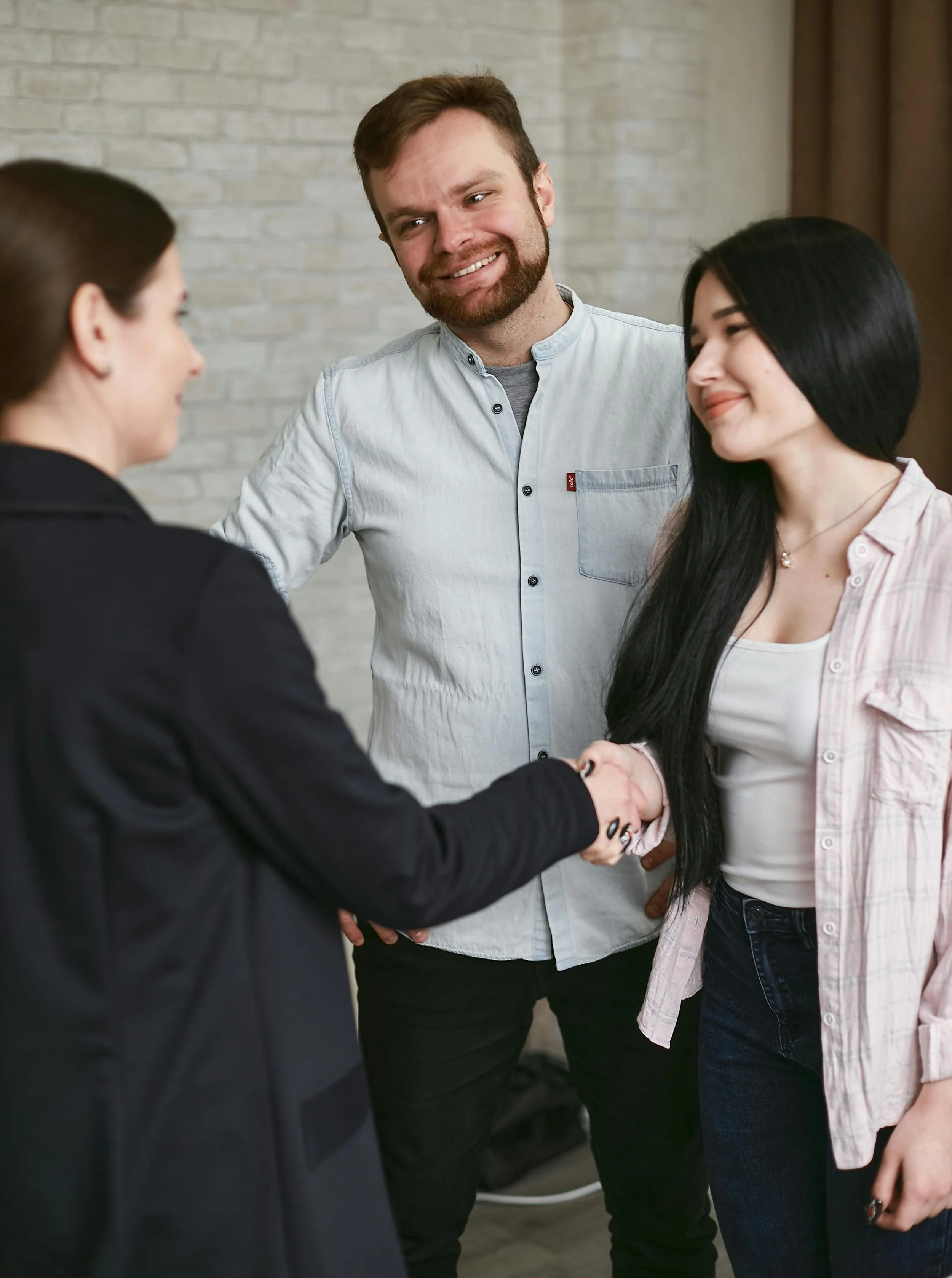 Immigration adviser welcoming clients after successful visa consultation