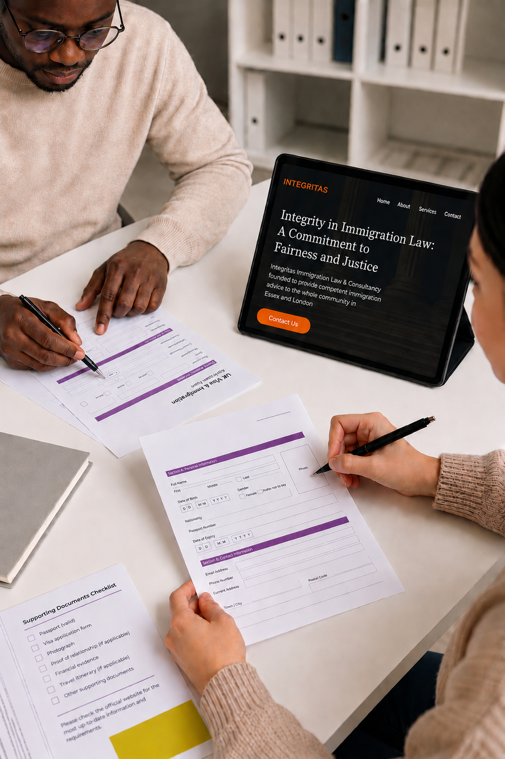 Completing a UK immigration visa application form with Integritas Immigration Law website on tablet