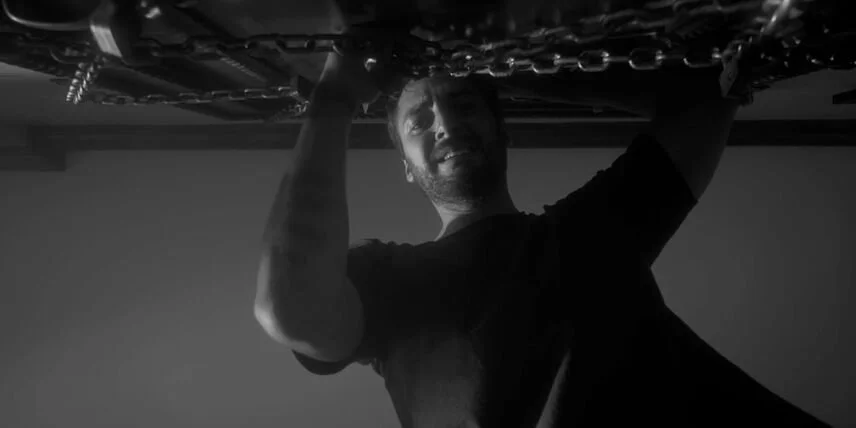 El attempting to push the door open, shot from below