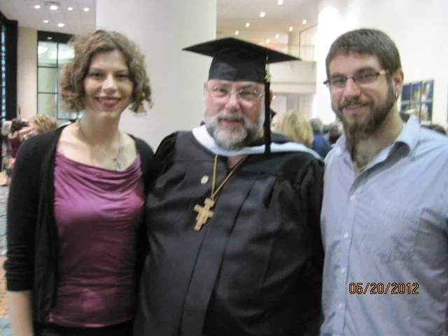 Liz with her dad and brother at their dad's MA graduation in 2012.