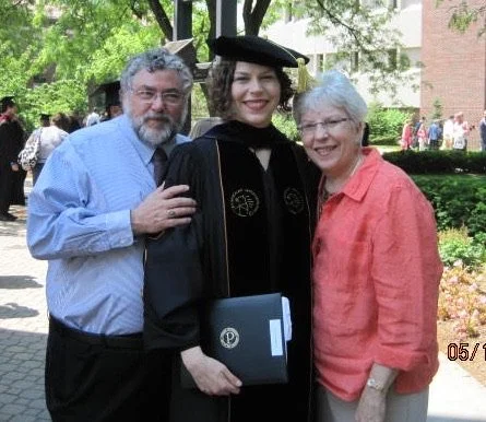 Liz with her dad and mom at Liz's PhD graduation in 2012.