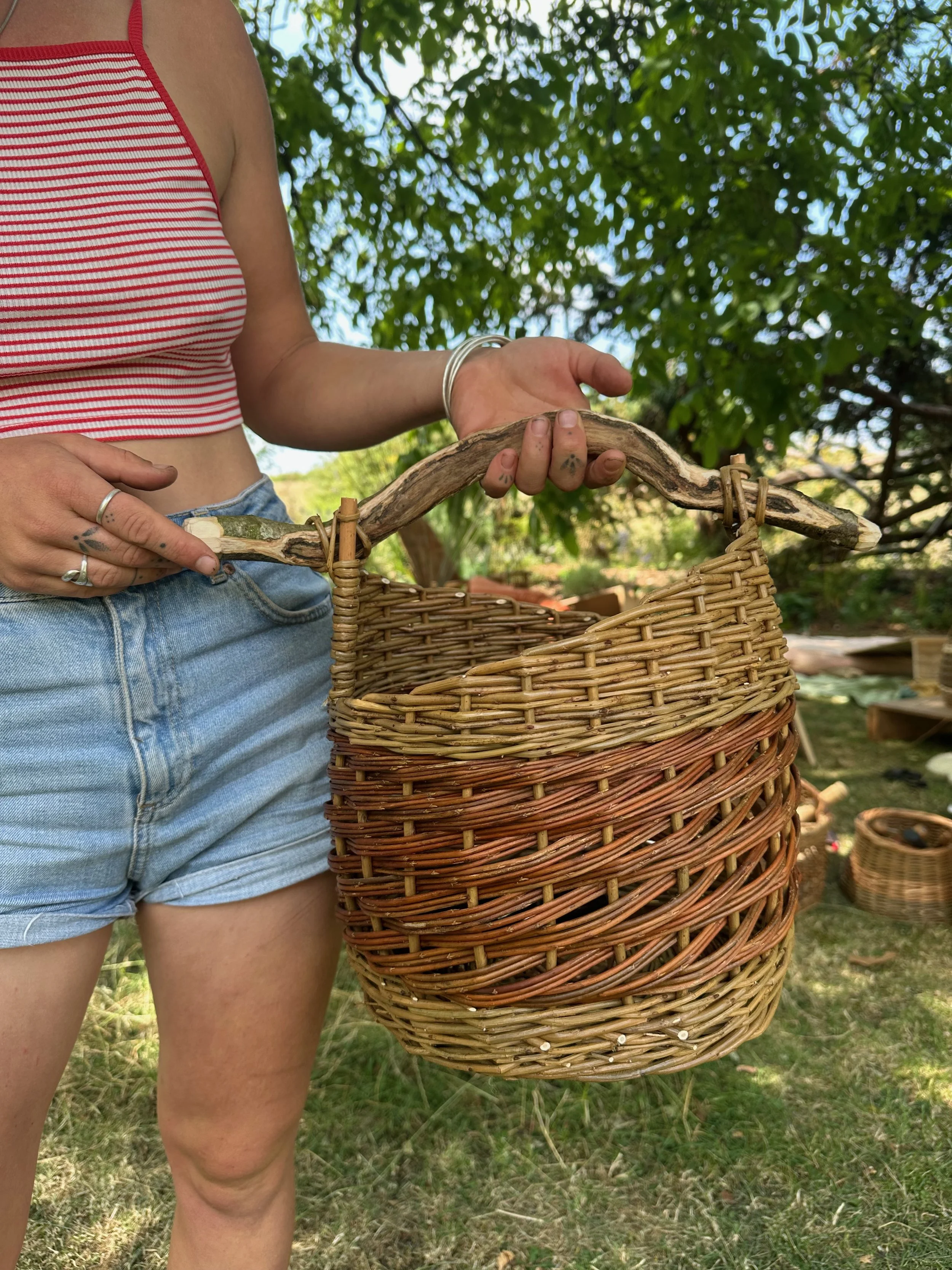 Finished asymmetric basket with stick handle
