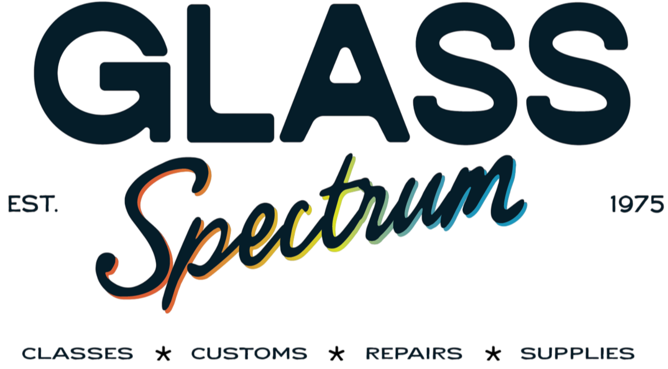 Logo for Glass Spectrum, established in 1975, featuring the word 'Glass' in large dark blue letters, with 'Spectrum' in colorful cursive below, and words 'Classes', 'Customs', 'Repairs', and 'Supplies' beneath.