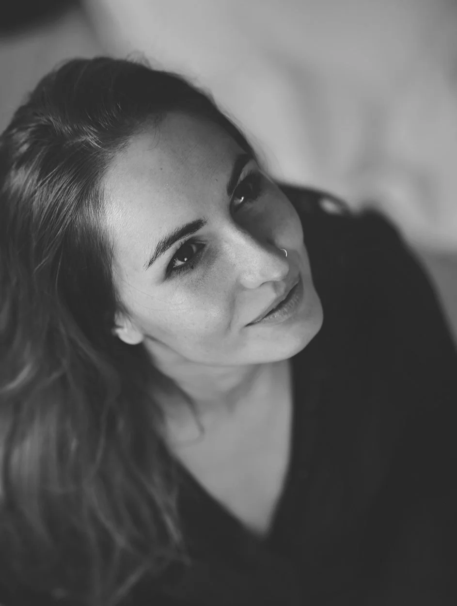 black and white image of young brunette woman looking up to the side