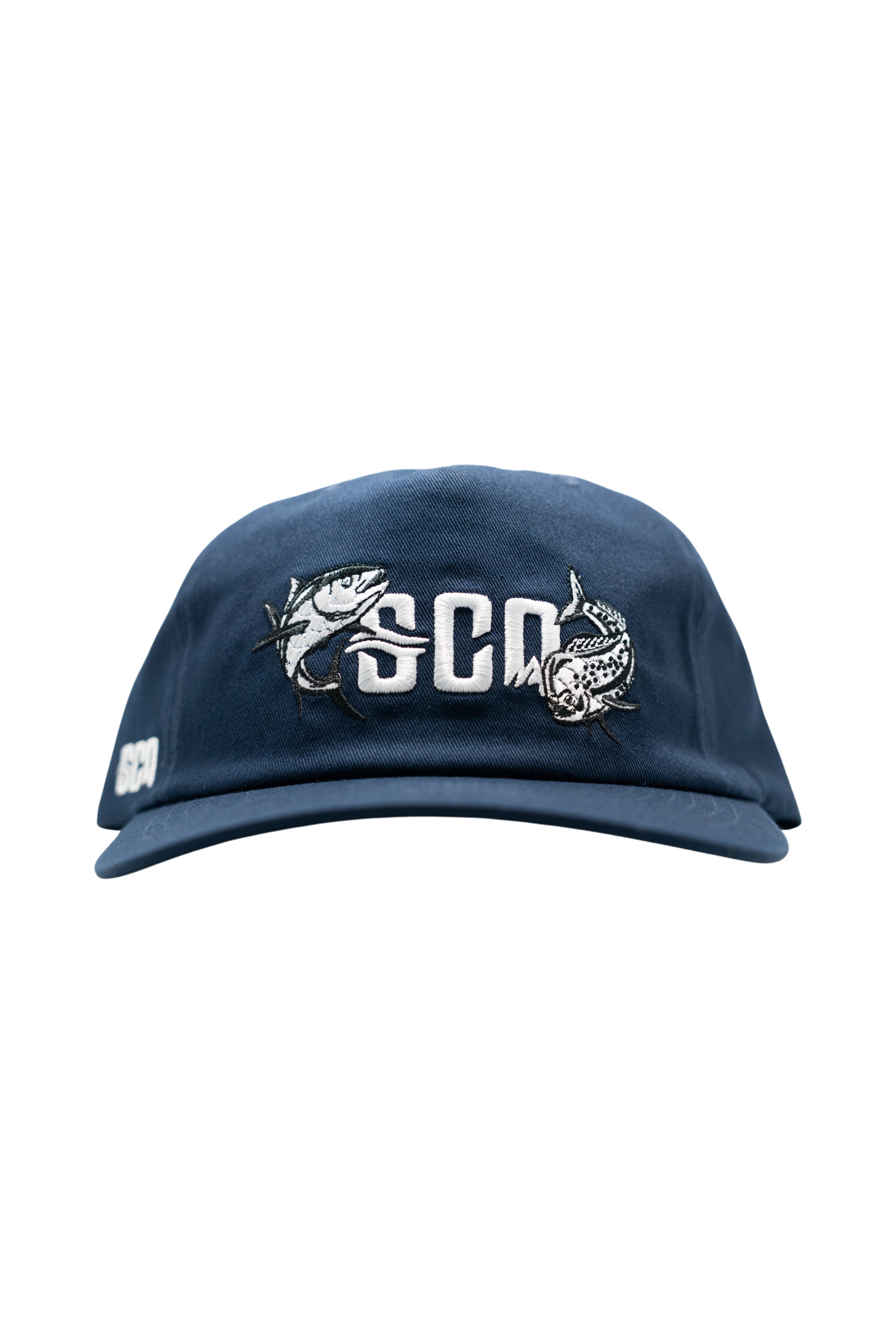 A blue cap with embroidered fish and the letters 'SCGM' on the front.