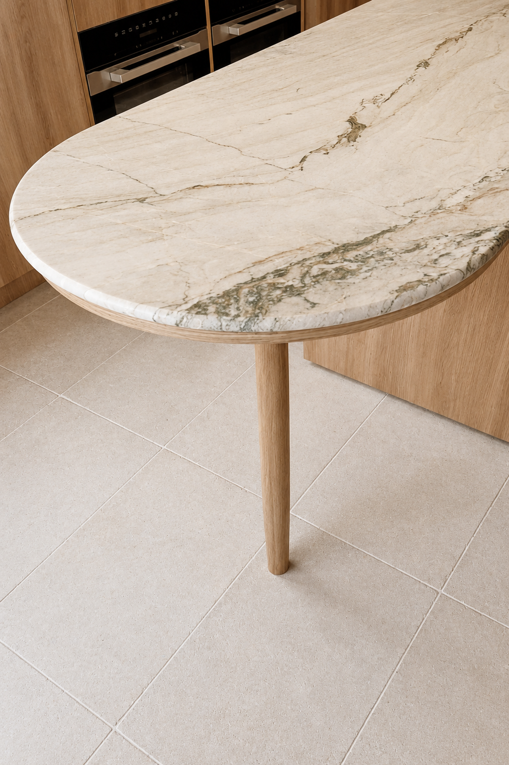 A marble-topped kitchen table with a single wooden leg in a modern kitchen setting.