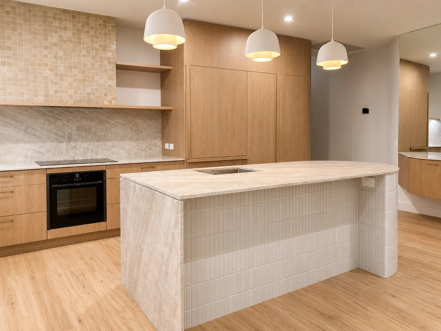 MINDI ST, DOONAN .

A refined balance of warmth, texture and form. Curved detailing and natural stone create a kitchen that's as functional as it is beautiful&mdash;crafted to elevate everyday living.

Interior Design &mdash; Renegade Design Studio 
