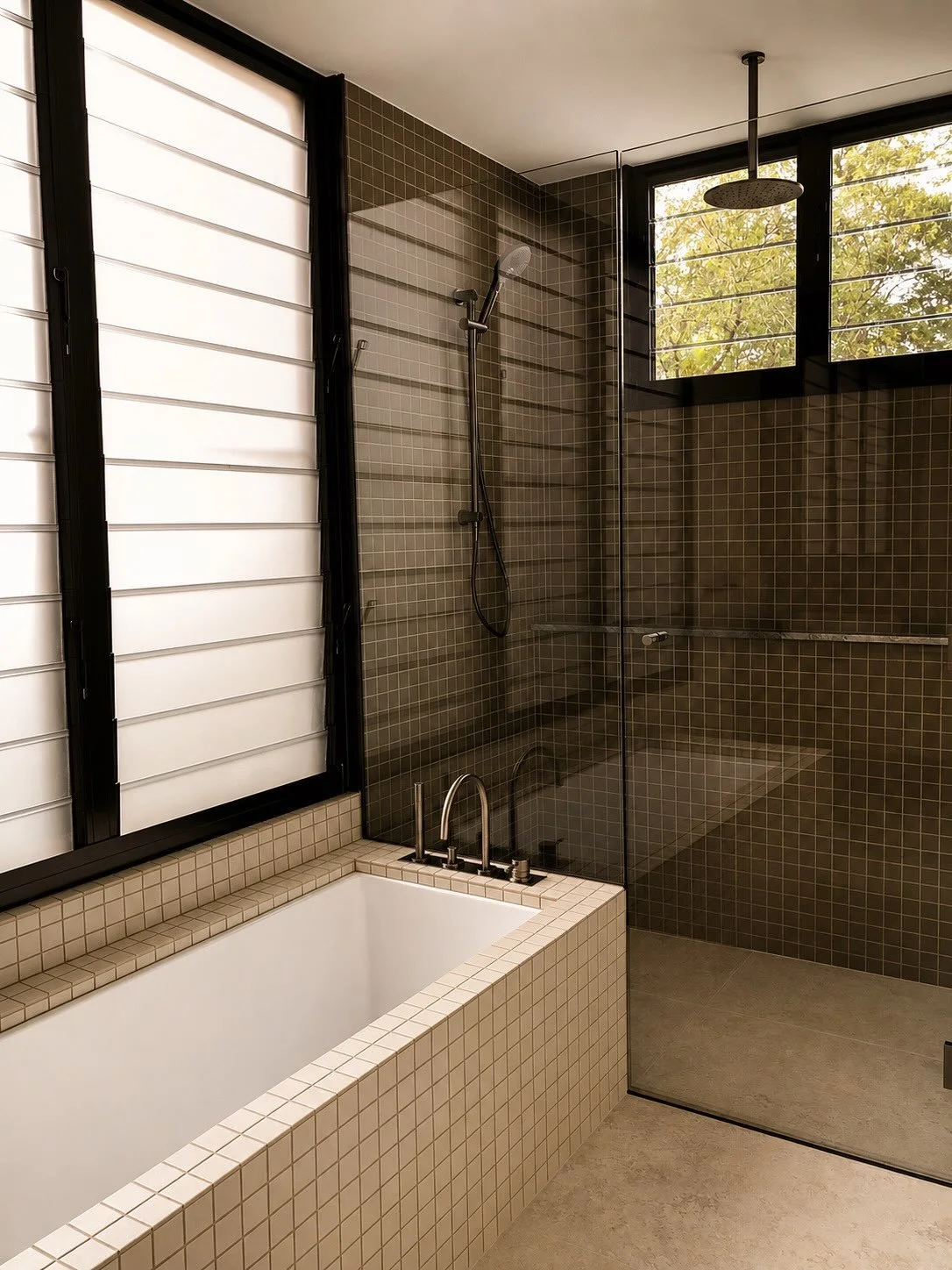 FOREST RIDGE, DOONAN 

Every element within this bathroom has been carefully considered, creating a space that feels effortlessly refined. Tonal tiling is complemented by gunmetal tapware, bringing depth and contrast to a clean, contemporary finish.

