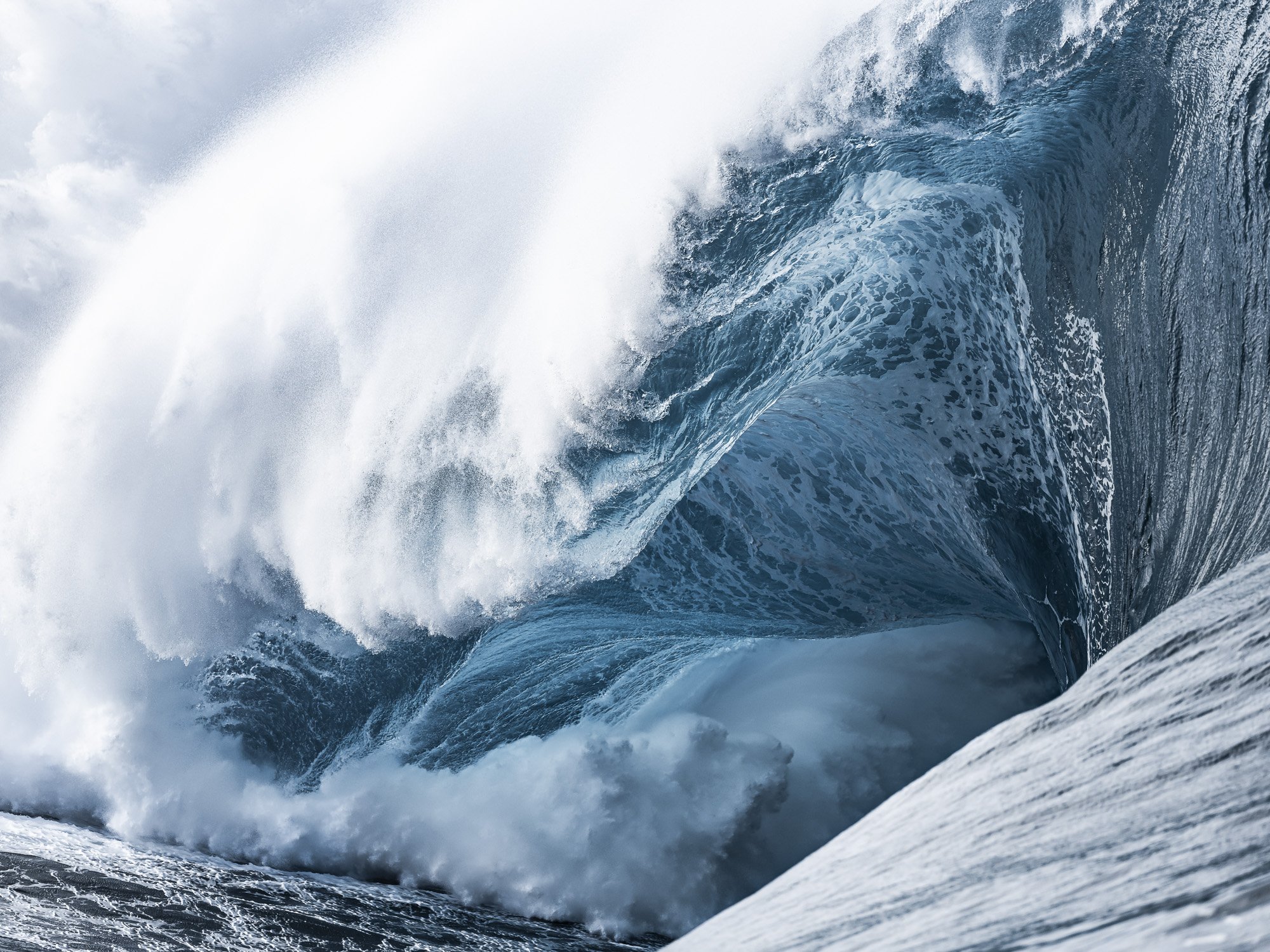 Close-up of a large Teahupo'o wave curling and crashing.