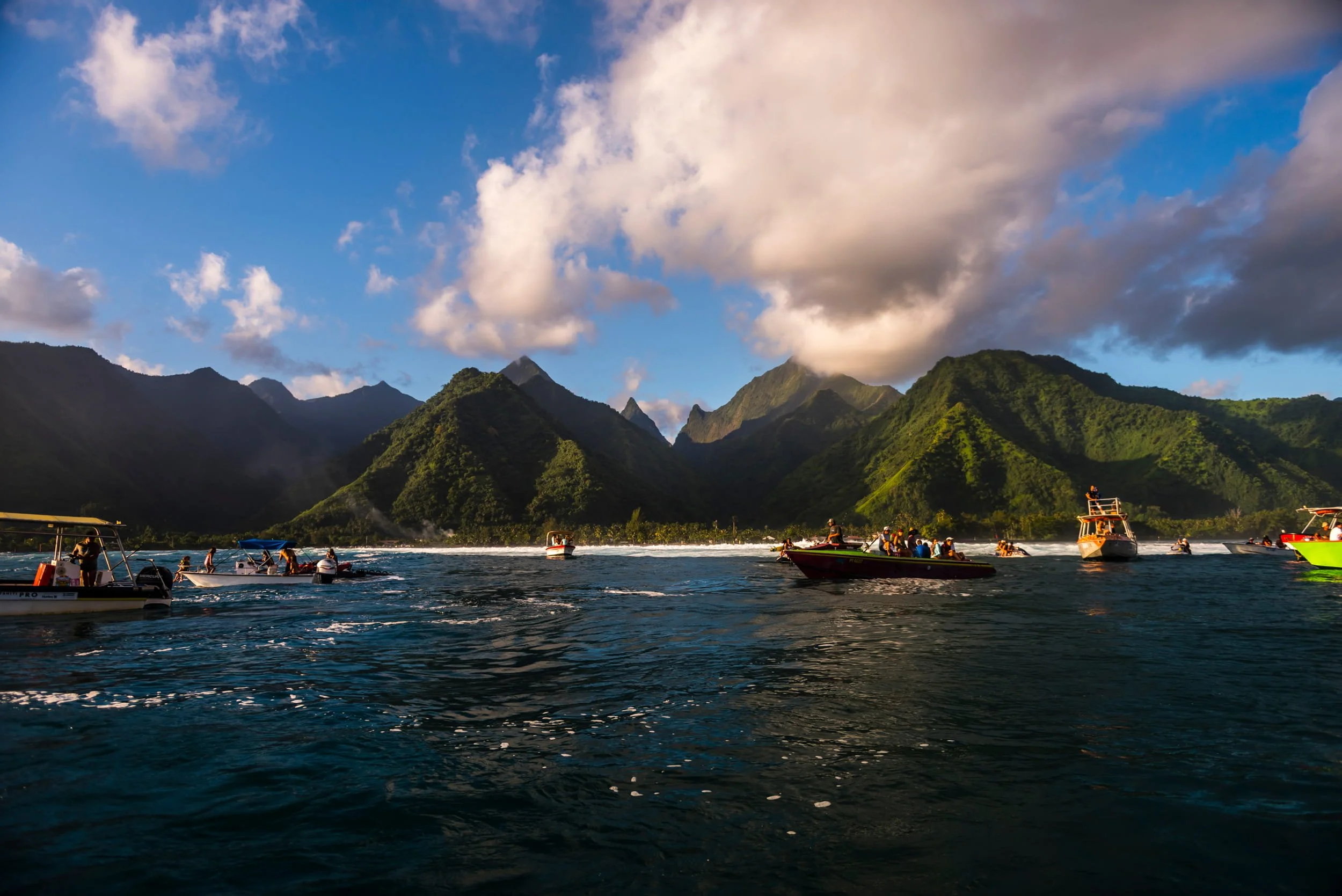 Boats on surf line up in Teahupo'o, French Polynesia