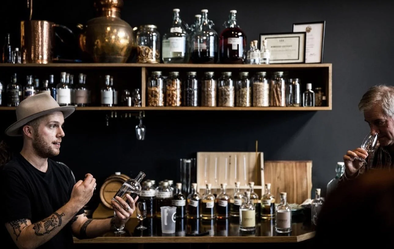 Things to do on Flinders Island | Flinders Island Aviation | Person looking at bottles at Furneaux Distillery