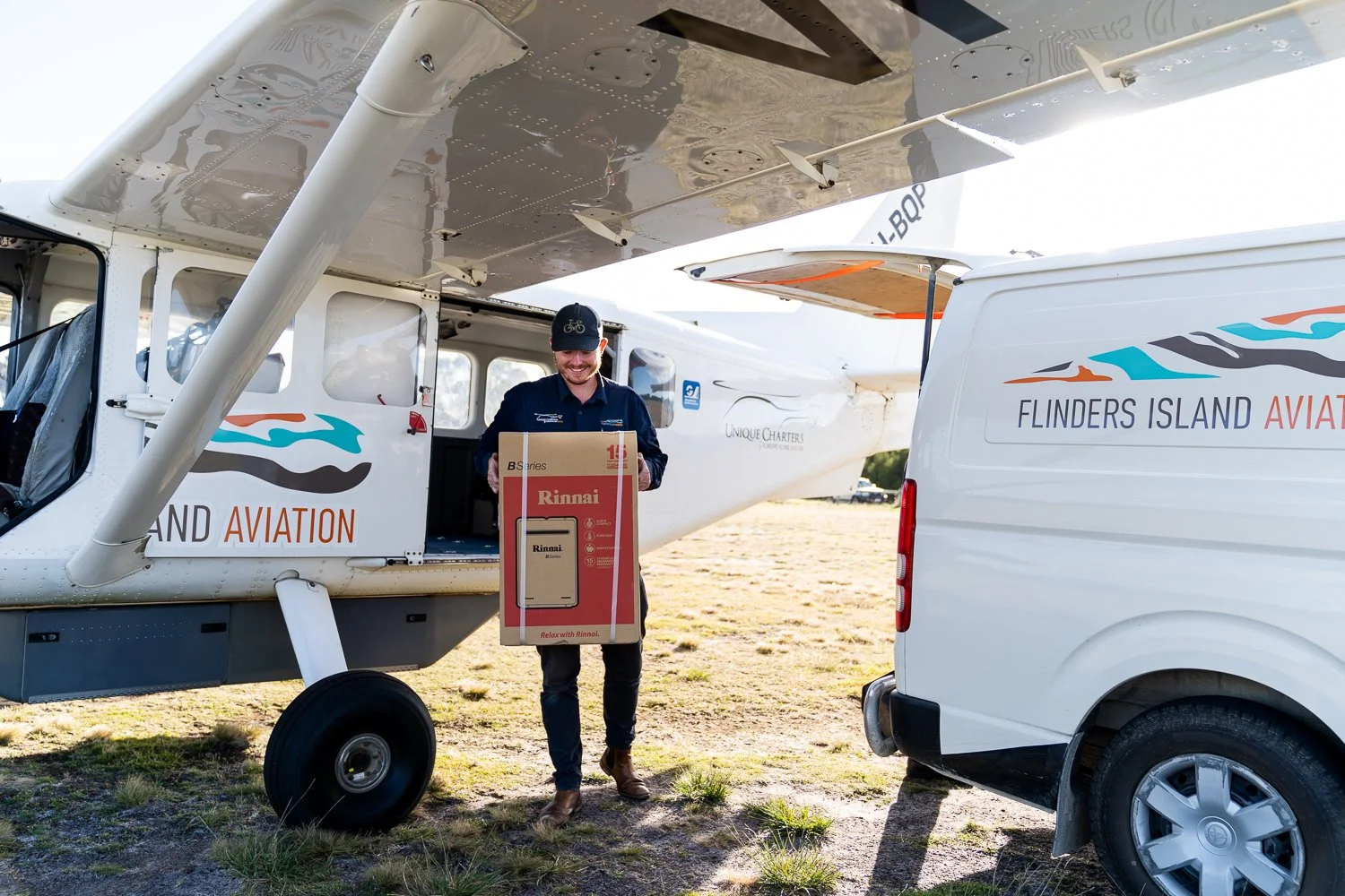 Flights to Flinders Island | Flinders Island Aviation | Pilot unloading freight from plane