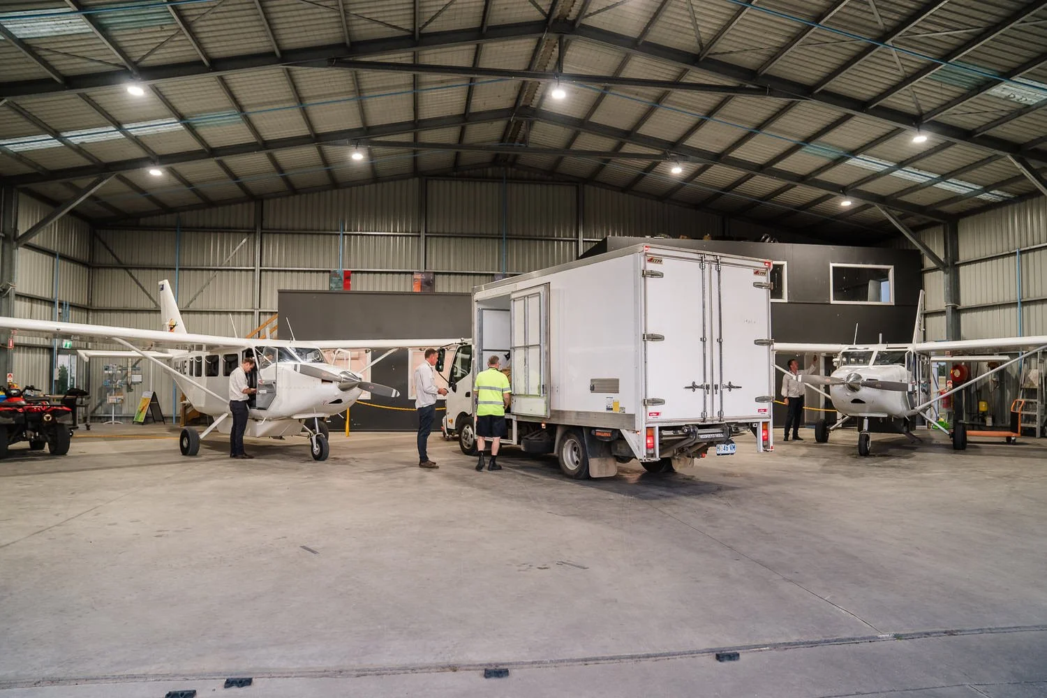 Flinders Island Freight | Flinders Island Aviation | Truck unloading freight inside Flinders Island Aviation hangar