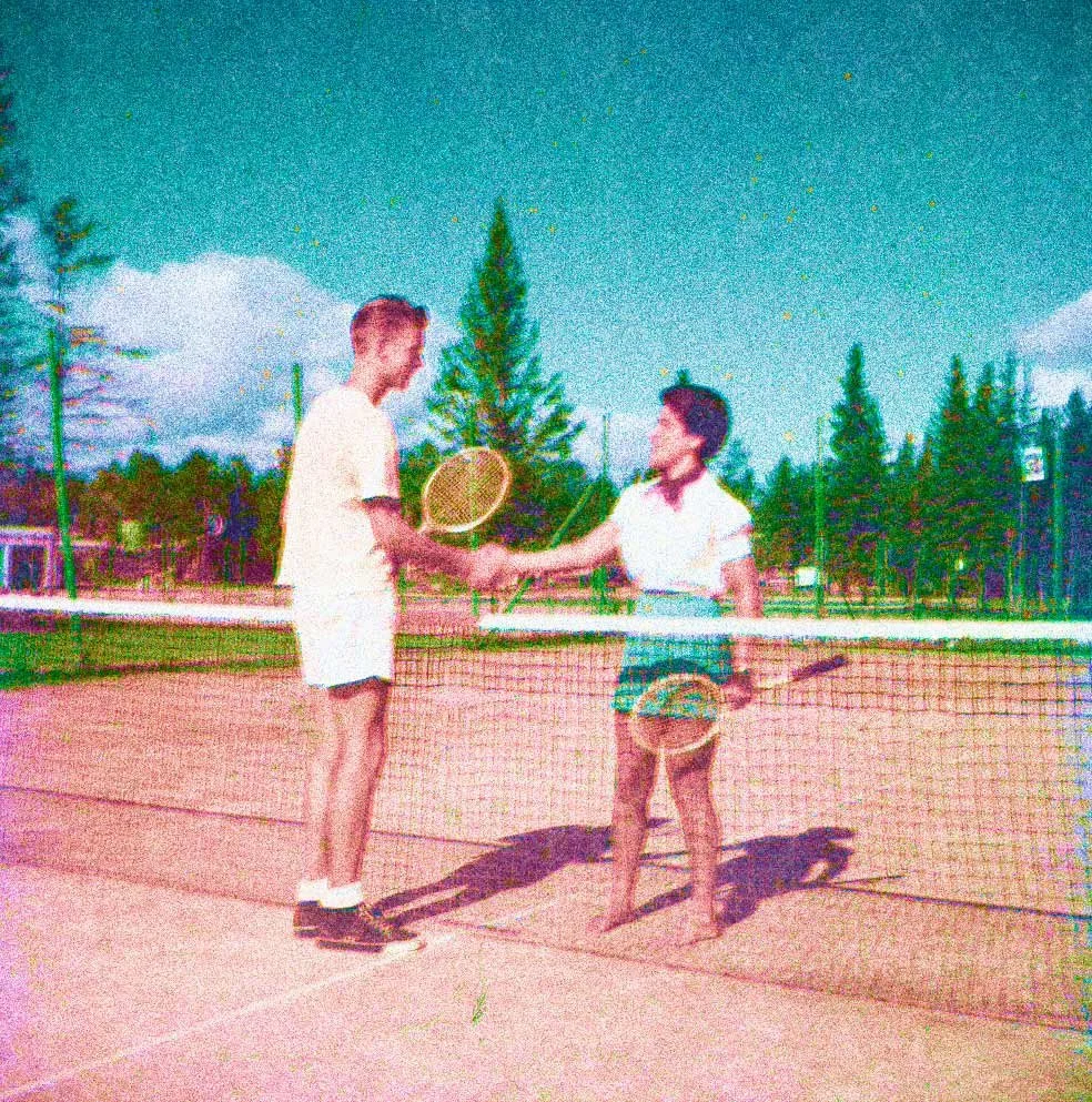 vintage image of a man and a women shaking hands over a tennis court net
