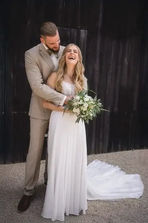 Bride%2Band%2BGroom%2BLaughing.%2BThis%2Bbeautiful%2Bphotograph%2Bcaptures%2Ba%2Bcandid%2Bmoment%2Bof%2Bpure%2Bhappiness%2Bbetween%2Ba%2Bbride%2Bin%2Bher%2Belegant%2Bwhite%2Bwedding%2Bdress%2Band%2Ba%2Bgroom%2Bin%2Ba%2Bstylish%2Btan%2Bsuit.%2B.webp