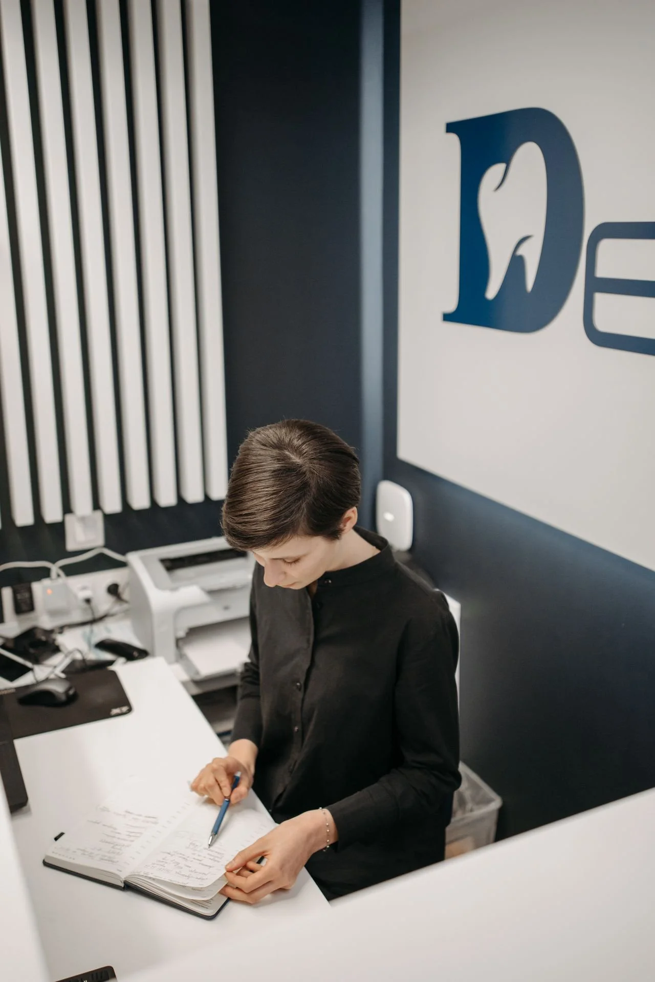 Dental professional working at a computer in a dental office