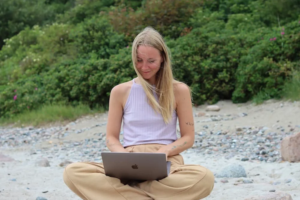 digital nomad at laptop working remotely in her dream career
