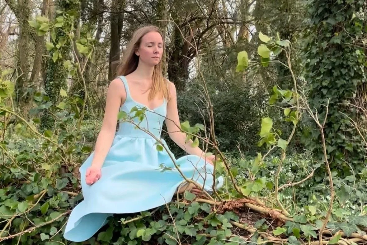 a woman in meditation to reconnect with her heart and joy