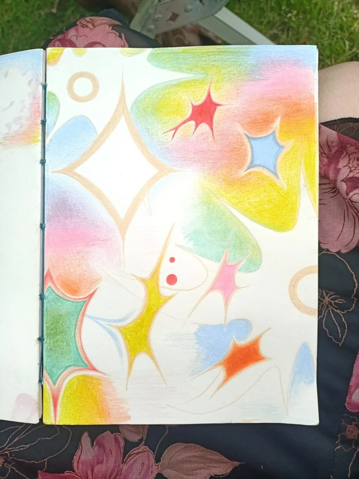 Colorful abstract doodle with star-like shapes in red, blue, pink, yellow, and green.