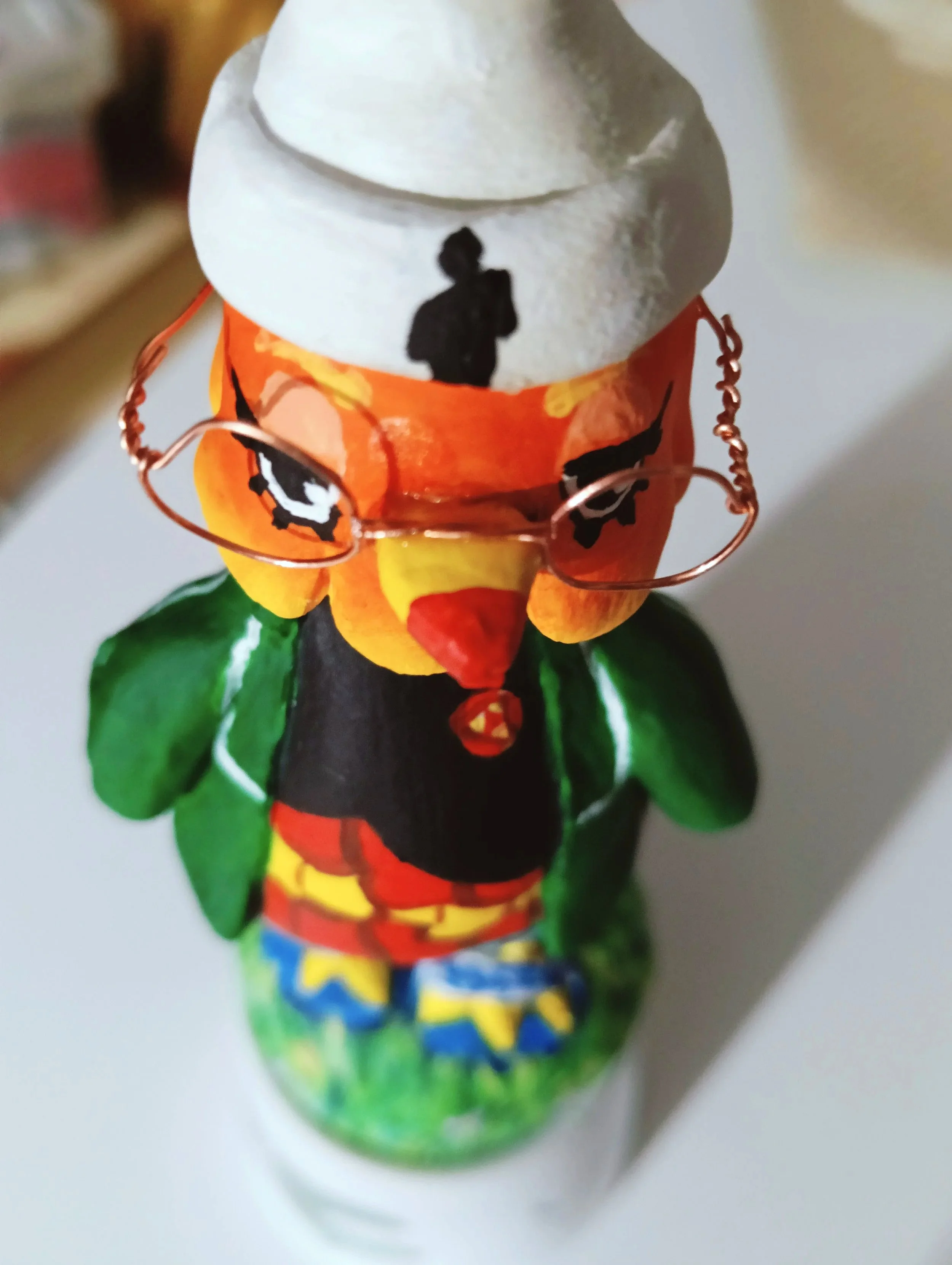 Colorfully painted clay sculpture of the bird Broffina from Animal Crossing.