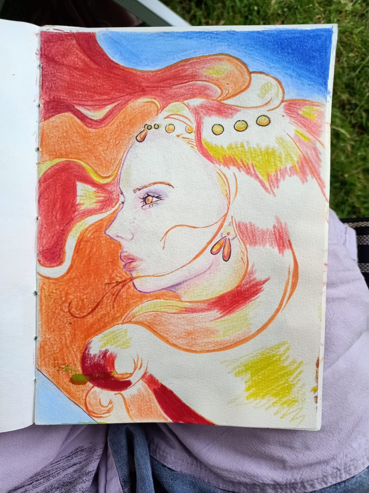 A colorful drawing of a woman's profile with flowing hair in shades of red, orange, and yellow, against a background of blue sky inspired by the movie Ponyo.