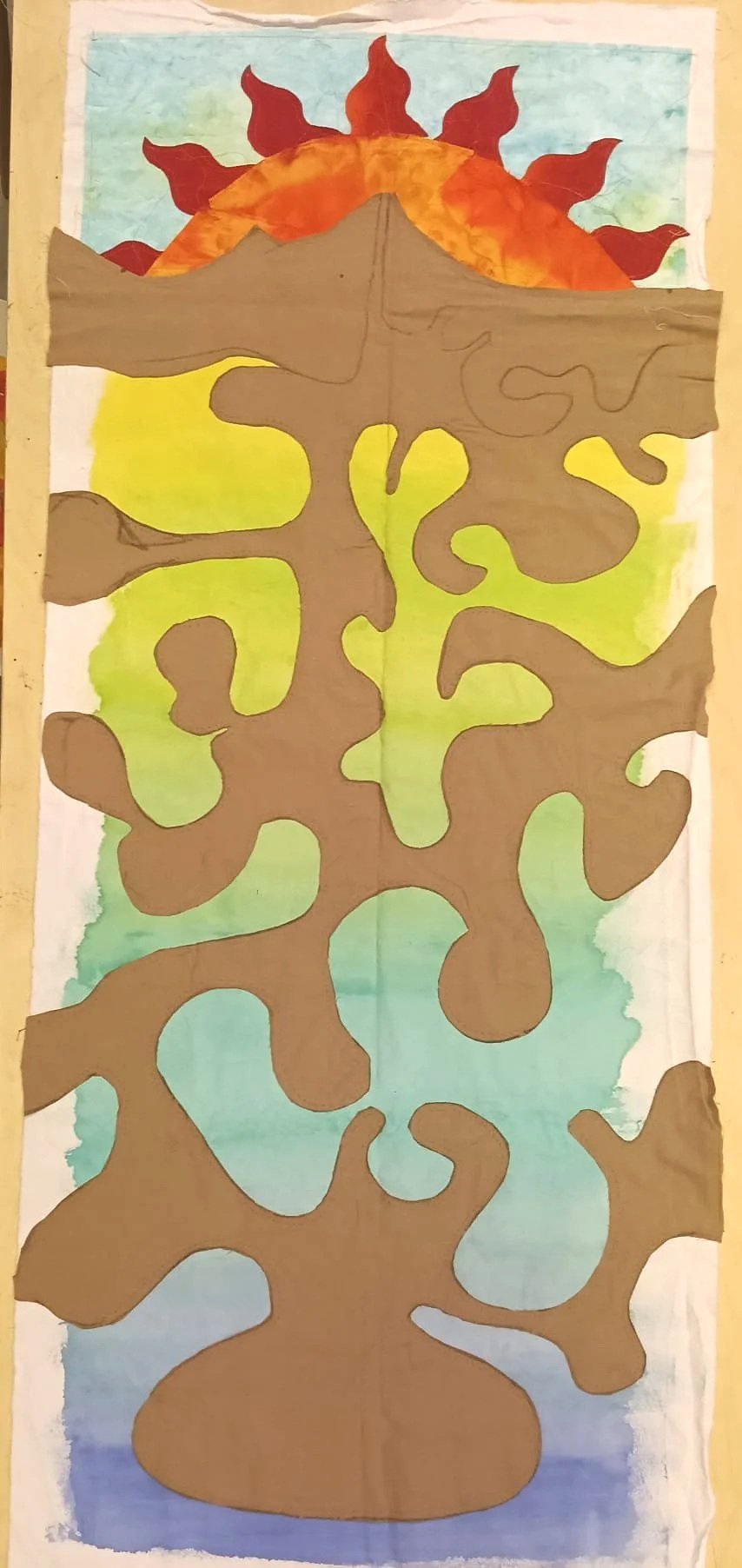 A colorful, artistic depiction of a tree with swirling branches, a mountain, and a sun with flames or rays in the background, set against a gradient sky transitioning from blue to yellow.