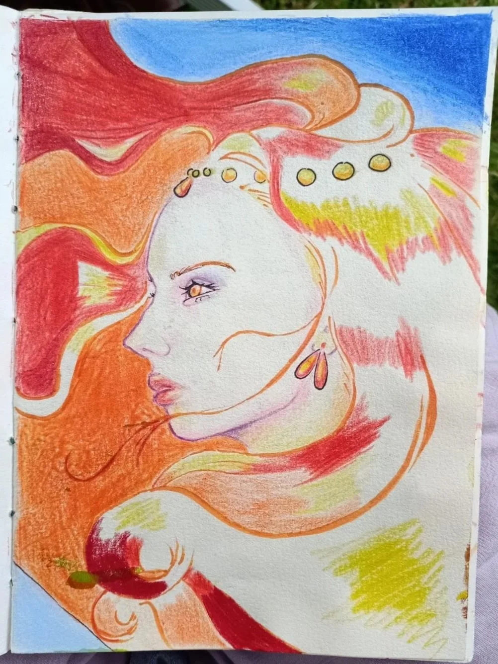 Colorful artistic drawing of a woman's face in profile with flowing hair in warm shades of red, orange, and yellow, and a blue sky background inspired by the movie Ponyo.