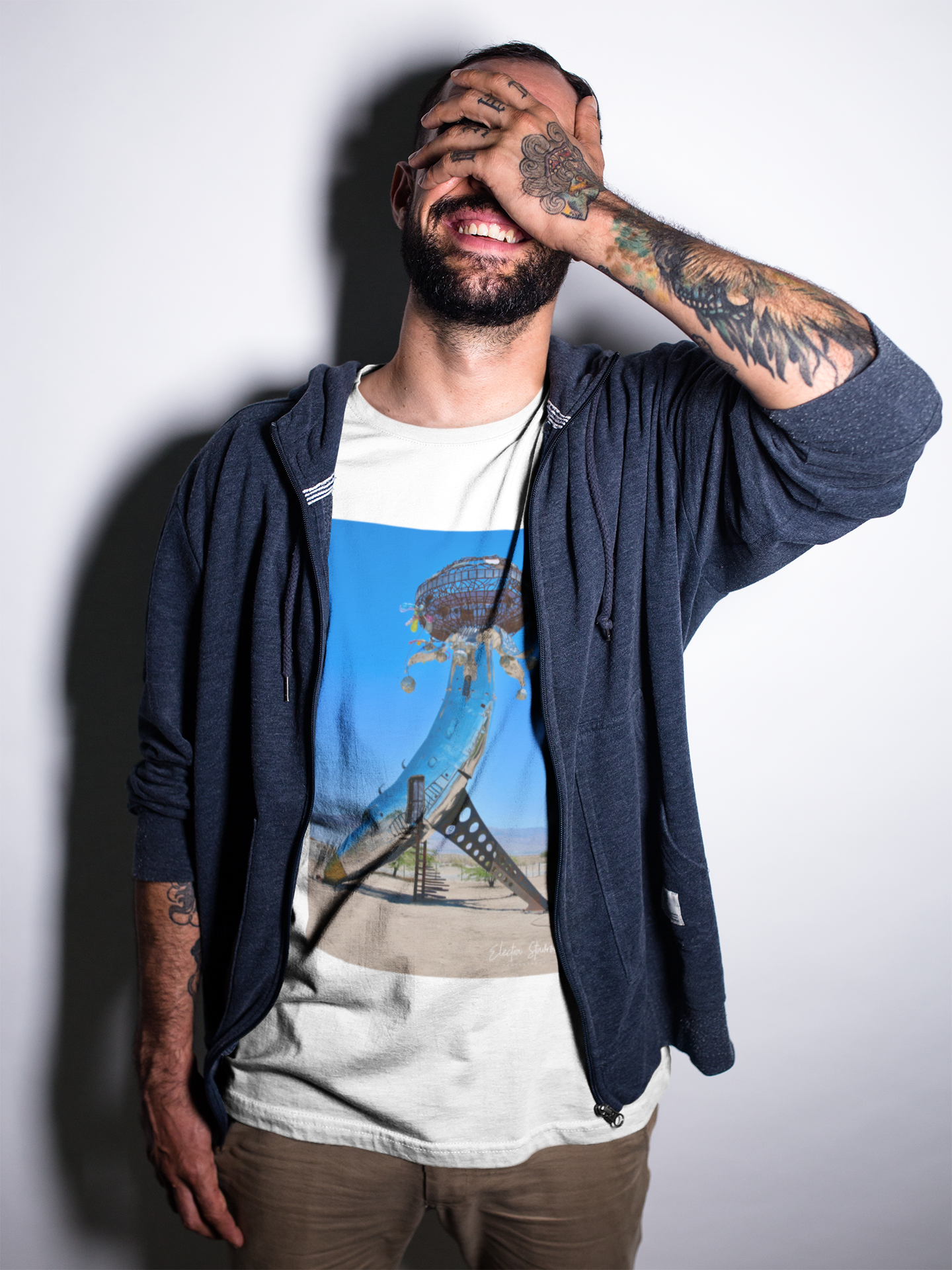 smiling-tattooed-man-wearing-a-t-shirt-while-at-a-studio-mockup-a17024.png