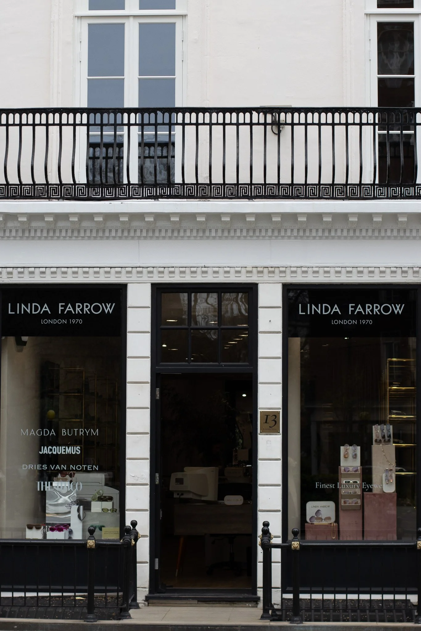 Storefront with the sign 'Linda Farrow London 1970' and display window showcasing luxury eyewear and jewelry. Linda Farrow.