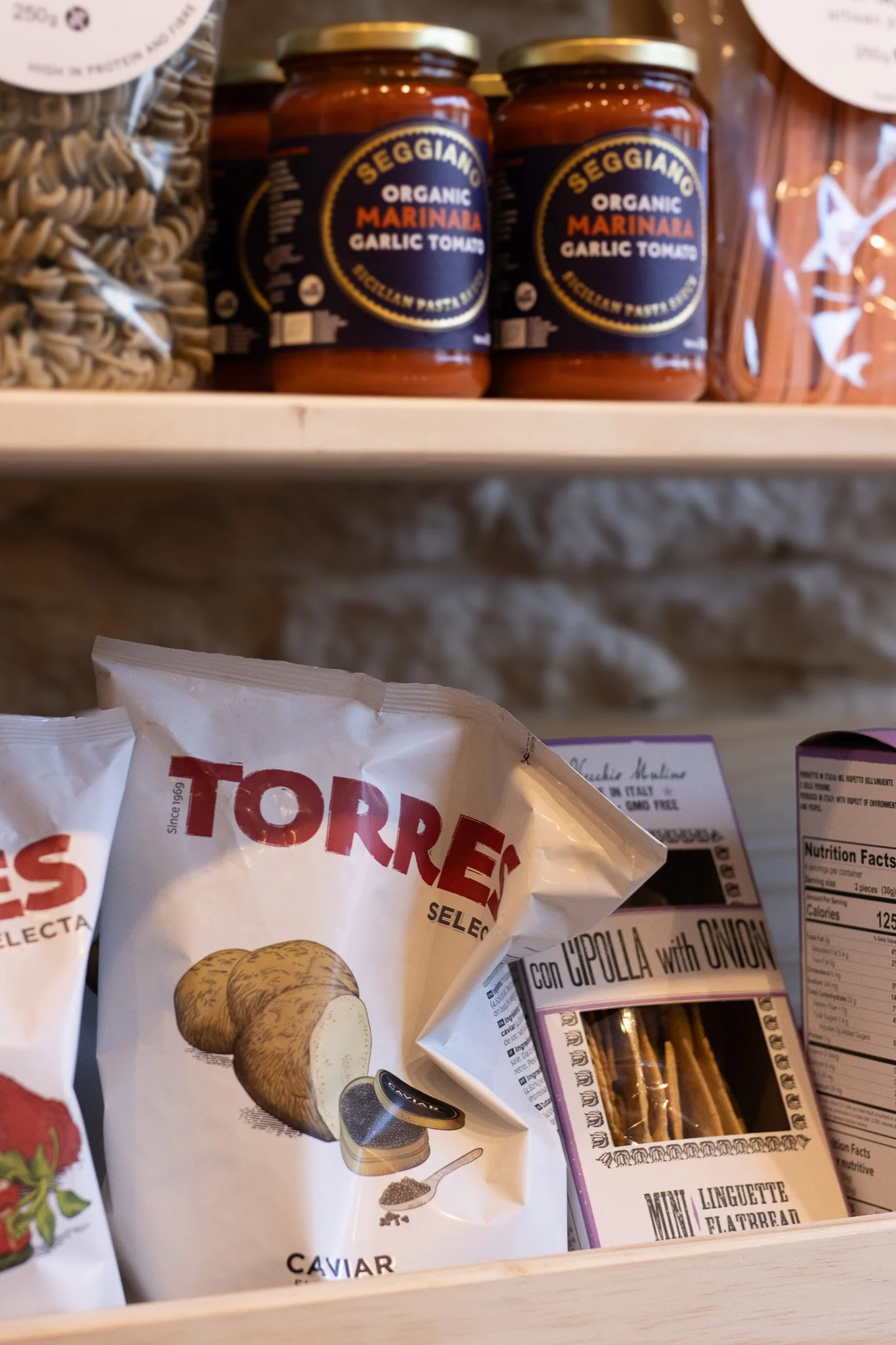 Jars labeled 'Seggiano Organic Marinara Garlic Tomato' on a grocery shelf. The Cotswold Farm. 