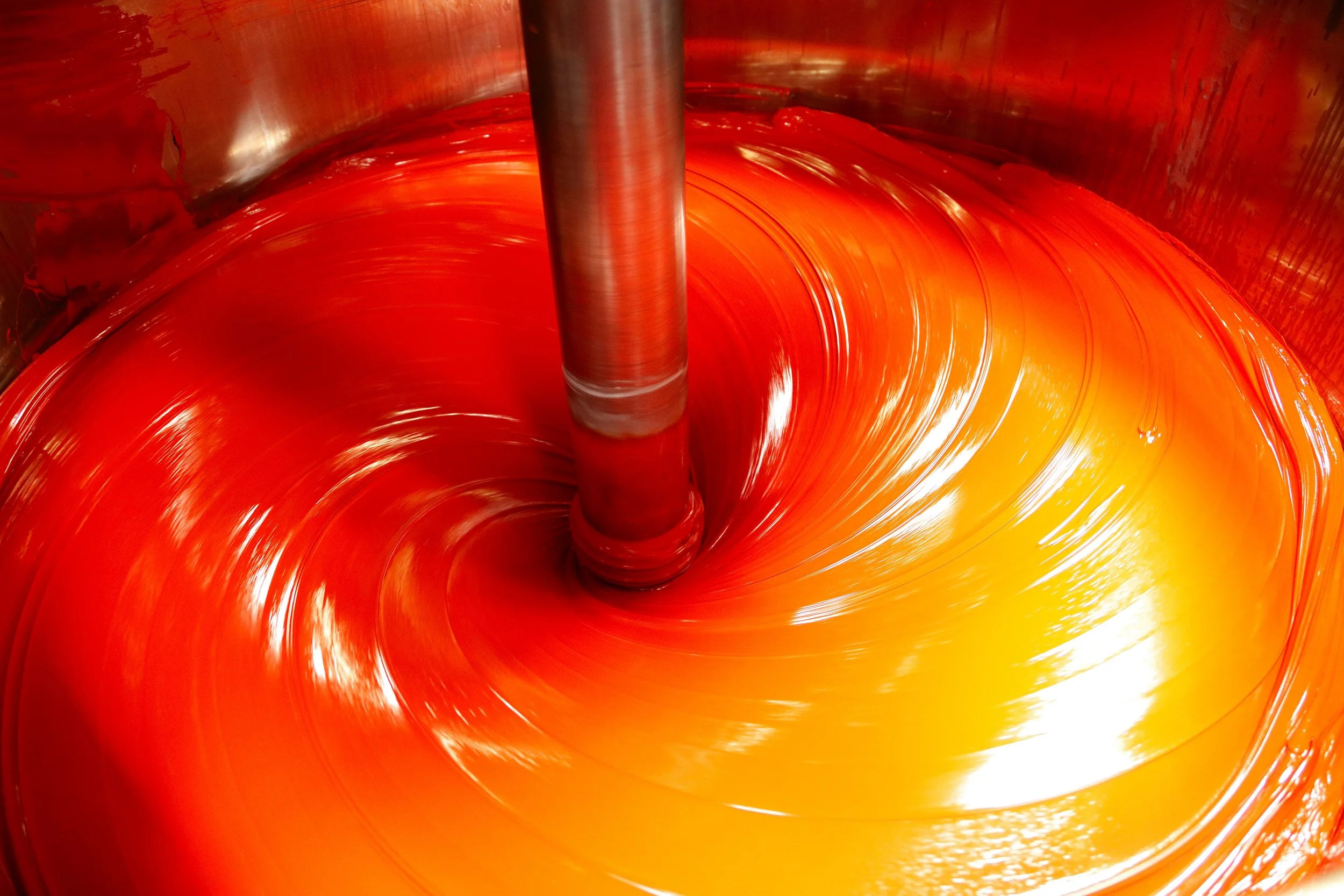 Close-up of coloured offset ink being mixed, representing Siegwerk’s feature on sustainable inks and coatings in the June 2026 Green Sustainability Magazine.