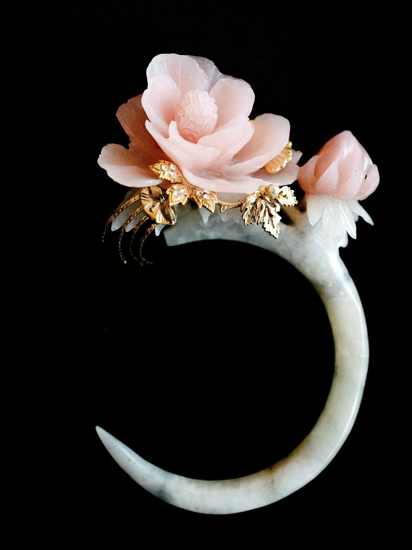 A jade crescent crowned with soft and delicate florals and accents of gold.

Celestial Bloom &mdash; a special showcase of elegance with @stellalunardy @lunebystella at @langham_jakarta @tangcourtjakarta for this Lunar New Year supported by @bankbri_