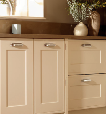 Kitchen cabinet with a beige countertop and decorative vases on top