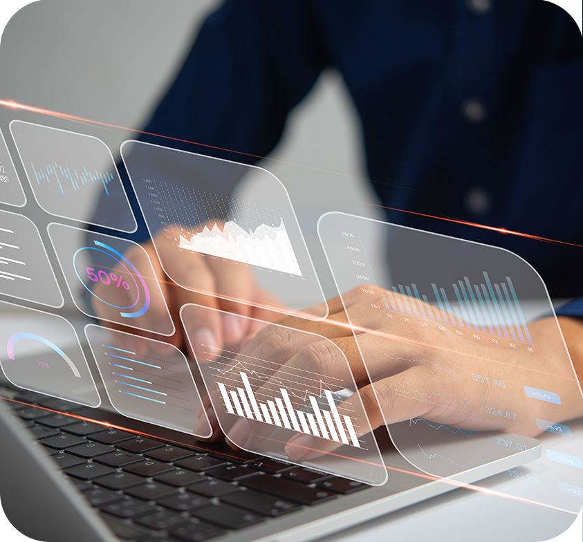 Person typing on a laptop with digital data visualizations overlay, including graphs and charts.